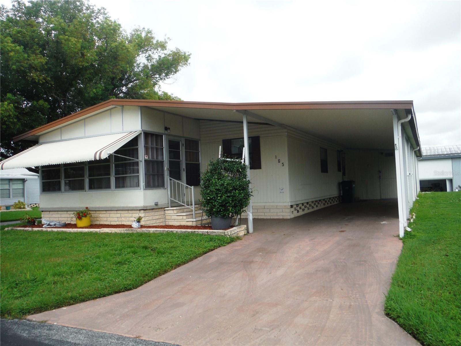 2 bedroom 2 bath with an office on a deeded corner lot 60X80 included in the price. This property allows a cat or a dog up to 25 pounds. One person needs to be 55 years old or more to buy and live in this community. This home has 3/4 inch plywood subfloor with laminate floors on top and ceiling fans in most rooms. All appliances are included and the furniture you see is also included. Perfect for a snowbird starting out. There is even and electric fireplace in the living room and a pantry in the kitchen. The master bedroom has 2 closets - one is a walk-in closet. The central heat & air was installed in 2019. There is a huge shed for terrific storage. The maintenance fee is $241/Month and it includes water, sewer, trash, lawn, private roads, clubhouse, heated pool & spa, gym, and shuffleboard. Move-in right away if you like - it is ready for you. Room measurements are approximate.
