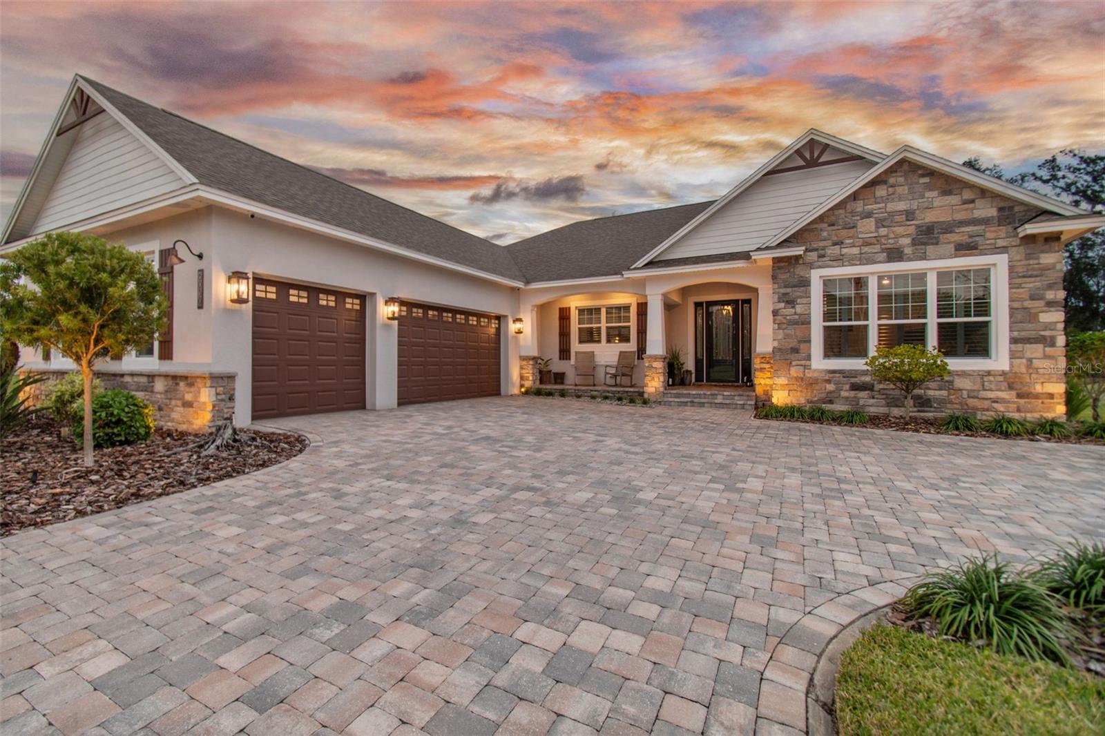 UPGRADED CRAFTSMAN STYLE HOME WITH POTTERY BARN FEEL IN ABBEY OAKS - Artfully arranged 4-bedroom, 3-bath custom home blends rustic charm with modern conveniences in a split floor plan with open concept begging for entertaining. The paver driveway draws you into the home and at night, the outdoor lighting accents the property well. The entertaining does not stop at the interior open concept floor plan; open the lanai sliding doors and your guests will effortlessly enjoy the well-appointed lanai and spectacular pool area. This offers so much more square footage for entertainment and enjoyment of all Florida living offers! Upon entering the front door an expansive great room welcomes you and effortlessly blends the kitchen and dining space into one functional family gathering spot. The centerpieces of these spaces are the custom steel and copper trimmed exhaust hood and gas fireplace. Nice touches like warm porcelain wood tile throughout, a cedar mantle, and wood beam ceiling complete the design. The sliding doors expand the space into the screened-in lanai that leads to a masterpiece of a pool complete with spa and eight (8) waterfalls overlooking a pond. The culinary artist will be excited to see the large center island and custom adjoining pantry with custom shelving. Maple glazed cabinets, granite countertops, a wine cooler, and stainless-steel appliances complete this dream kitchen and living space. The huge Master Suite features a tray ceiling, en-suite bath complete with a custom-made barn door, double vanities with maple glazed cabinets, a gorgeous free-standing tub with stone tile accent wall and a glass enclosed shower. Dual walk-in closets with custom shelving top off the space and provide excellent storage. Opposite the Master suite is a couple of bedrooms with custom shelving, a custom accent wall in one bedroom, and shared bath. A fourth bedroom with en-suite bathroom that doubles as a pool bath and leads to the lanai area. Numerous upgrades were performed to the home after being built, including the addition of the screen-in gorgeous pool area, a backup generator, the stove hood, upgraded custom wood shelving in all closets, surround sound with 2-zones, and trees and other plantings around the lot. See the listing for a complete list of upgrades. Abbey Oaks is a gated community on Ewell Road with convenient access to both Lakeland and Plant City. Additionally, it offers easy access to I-4 while maintaining the charm of a rural setting.