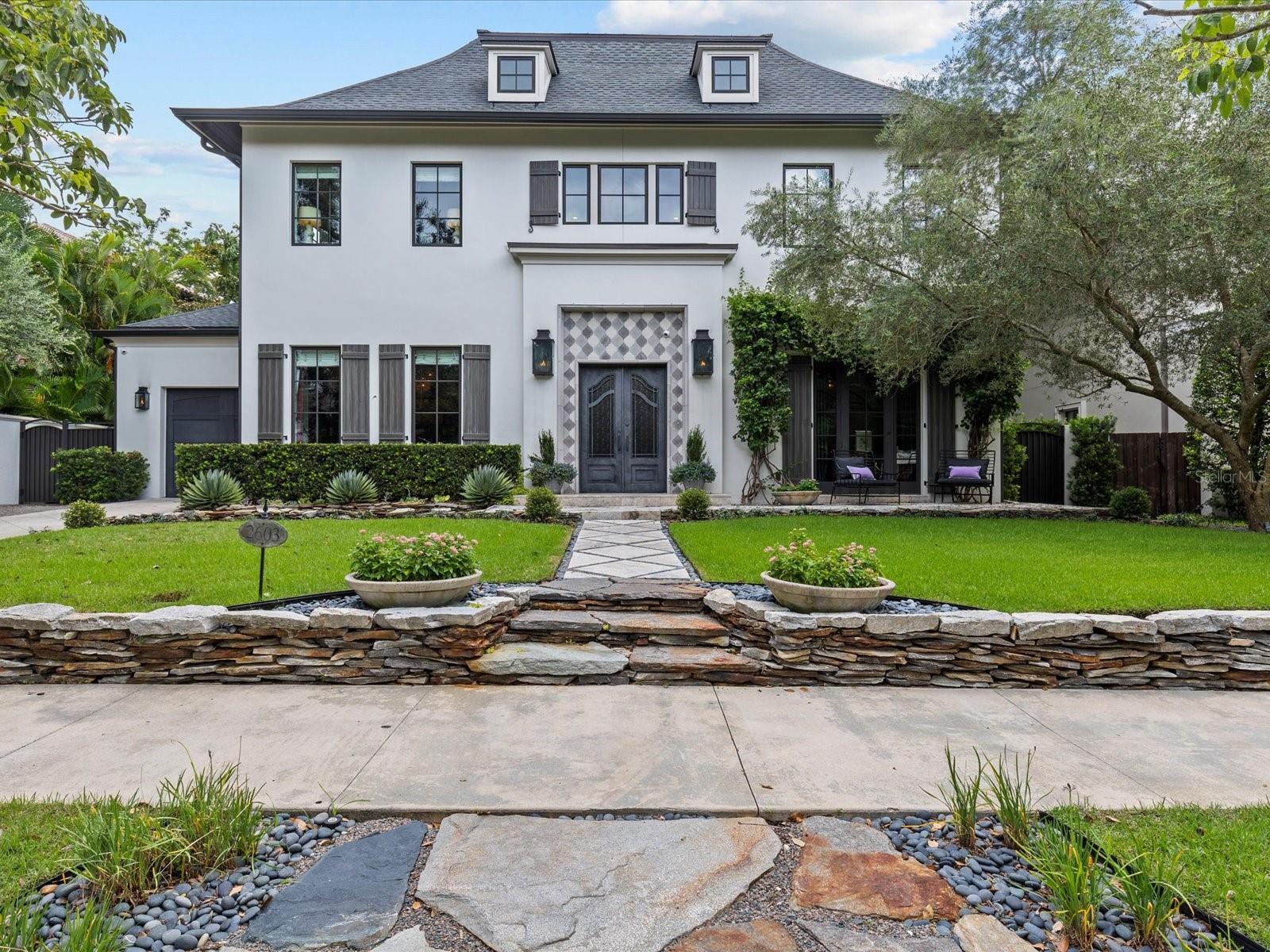 Under Contract! Back up offers are welcome. A Once-in-a-Lifetime Home, custom designed by Jordan Behar Architecture and the interior by Franco Pasquale Design Associates, offers a harmonious blend of modern and traditional styles, with French Normandy inspiration. Featuring 5 bedrooms and 4.1 baths, this home is rich in thoughtful details, premium materials, and expert craftsmanship. Exterior Structural Features: Constructed with durability in mind, this home features block construction, reinforced trussed roofing with metal caps, and Miami-Dade hurricane-rated fiberglass windows. Exterior architectural highlights include hand-painted shutters, stone knee wall, and travertine walkway surrounded by mature landscaping with Tabebuia and Olive trees that complement the home's aesthetic. The Backyard has premium grass turf, saltwater extra deep pool and the canopy of a beautiful Grand Oak. The scandanavian-inspired interior emphasizes clean lines, concrete floors, and a neutral color palette, providing an elegant backdrop for showcasing artwork. Upon entering through custom metal doors, guests are welcomed into a grand foyer with etched concrete floors and a wrap-around staircase with custom handrail and banisters. The main level is thoughtfully designed with four primary rooms, all filled with natural light. Flexible spaces include an office that doubles as a guest bedroom, and the living room expands seamlessly by opening an accordion glass wall to incorporate the outdoor living area. The heart of this home is its meticulously designed kitchen. It features a striking wood and mixed metal tiara hood as the center of the room, a raised walnut island bar, and separate bar nook. Equipped with top-of-the-line Thermador appliances: including a (gas-plumbed) induction cooktop, steam oven, traditional wall oven, Bosch dishwasher, and oversized refrigerator—the kitchen blends luxury with functionality. Danby marble countertops from Vermont and expansive commercial-grade picture windows flood the space with natural light, offering unobstructed views of the lush backyard. The first floor also includes a laundry room, an oversized single-car garage, and a convenient half-bath that serves the pool area. Upstairs Layout and Private Spaces: The second floor is split into two distinct wings. The primary wing features a vestibule with coffee bar, a spacious bedroom with sitting area, a dressing room with customer built in cabinets by California Closets and a luxurious bath with separate sinks, a two-person stone tub, marble floors, a multi-head shower, and a private sunbathing balcony. The secondary wing includes additional bedrooms, an entertainment room, a second laundry room, an AV closet, and a fourth bedroom with an ensuite bath overlooking the backyard. Attention to Detail and Custom Features: From oversized baseboards and crown molding throughout to custom-built closets in every bedroom, this home exudes sophistication and thoughtful design at every turn. This property is a true masterpiece, offering timeless elegance, modern functionality, and superior craftsmanship—a rare opportunity to own a home where every detail has been meticulously planned and executed. Walking distance to Bayshore Blvd; Hyde Park Village, Restaurants on Howard, and Palma Ceia Golf and County Club. Quick commute: 10 minutes to Downtown Tampa and TIA.