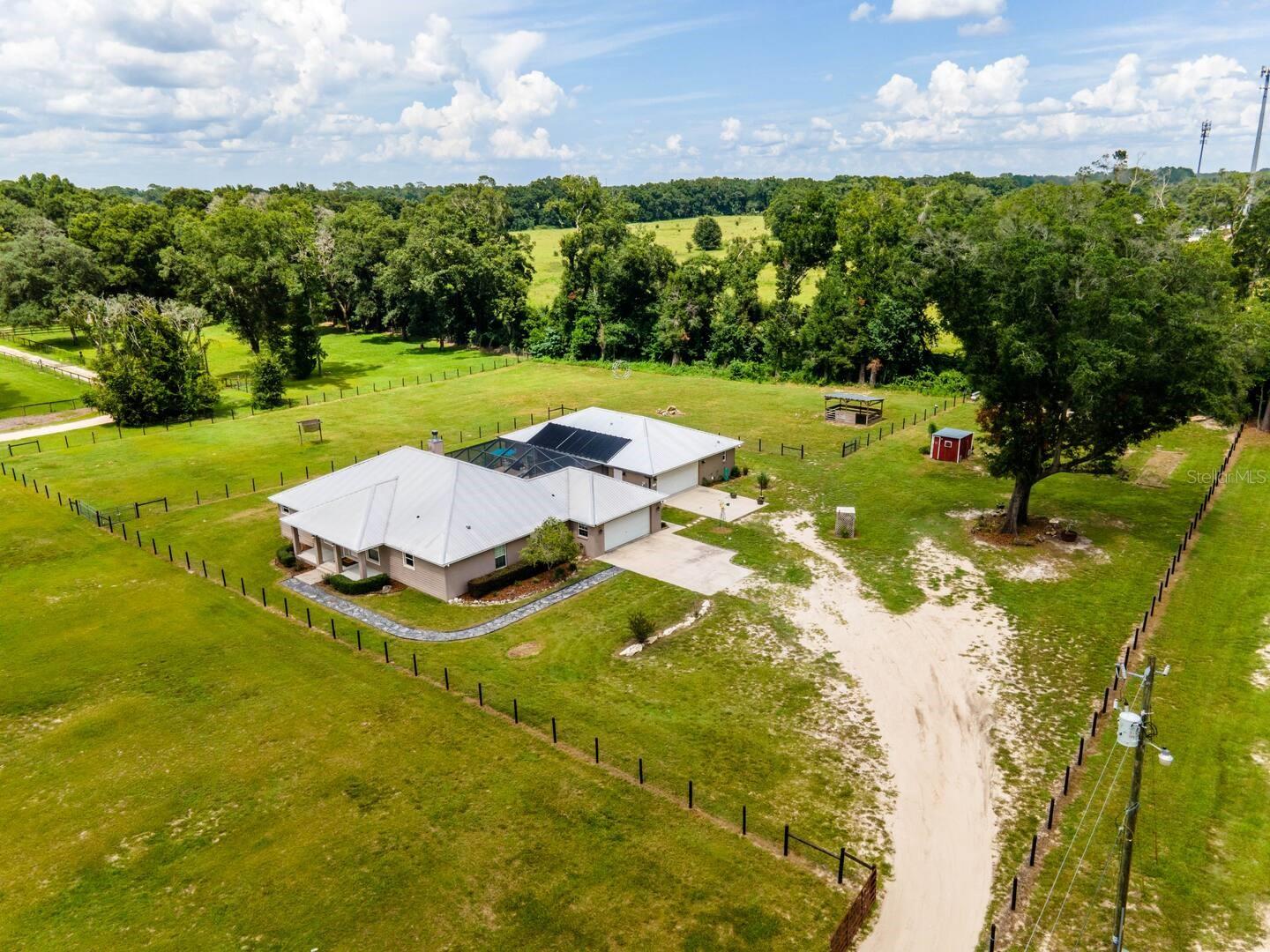 Welcome to 485 NW 71st Ave in Ocala – a rare opportunity to own two fully furnished single-family homes on 5 beautiful acres, perfect for multi-generational living, investment, or a blend of both!
The main residence features 4 spacious bedrooms, 2.5 bathrooms, a 2-car garage, and plenty of living space to accommodate family or guests. The second home, built in 2017, offers 3 bedrooms, 2.5 bathrooms, and 1,335 sq ft of well-appointed living space, along with its own 2-car garage and washer/dryer.
Nestled between the two homes is a screen-enclosed, solar-heated swimming pool—a shared oasis perfect for year-round relaxation or entertaining after a day at the nearby World Equestrian Center, just a short drive away.
Currently operating as a successful Airbnb, the property had a 78% occupancy rate in 2024, with at least 15 loyal repeat guests who return annually for events at the World Equestrian Center. This is a hands-off, easy-to-manage short-term rental thanks to a team of reliable local cleaners and efficient systems in place.
If you’d like to continue its use as an Airbnb, the seller is open to transferring all future reservations, a direct booking website, and even the repeat guest address book to the new owner. Whether you’re looking for a serene family compound, a proven income-producing property, or both—this is a rare find that checks every box.