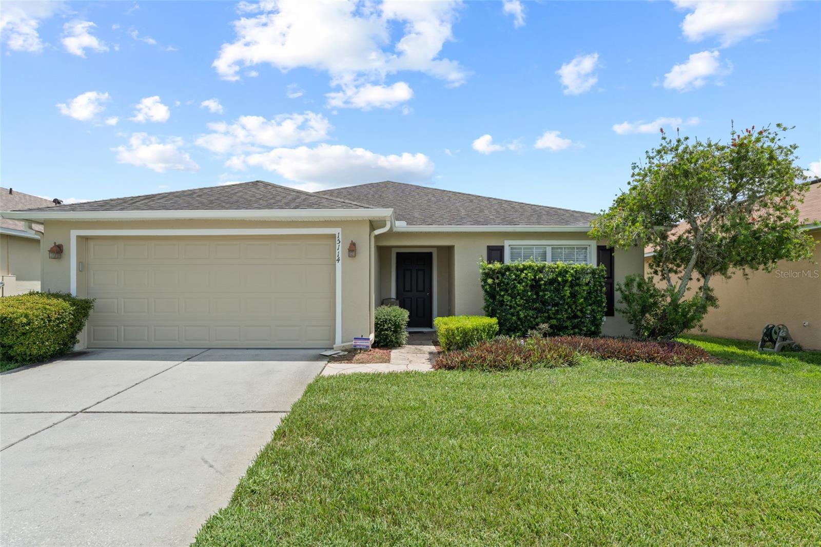 **This property qualifies for a closing cost credit up to $5,900 through the Seller’s preferred lender.** Welcome to a home where comfort meets tranquility. Step into nearly 1,700 square feet of warm, welcoming living space in this charming 3-bedroom, 2-bathroom single-family home, complete with a 2-car garage and serene water views. Manicured, sleek-cut grass and a covered front entry set the tone as you approach this delightful home. Inside, the foyer opens into a galley-style living and dining room combo with an open floor plan that effortlessly blends comfort and functionality. Natural light pours through the home, enhancing the sense of space and calm. Just to the right of the entrance is a cozy front-facing guest bedroom, featuring laminate flooring, a built-in closet, and ceiling fan—perfect for guests or a home office. To the left, a hallway leads to another carpeted guest bedroom and the private primary suite, which includes a spacious walk-in closet and an en suite bathroom with a relaxing tub/shower combo. The heart of the home is the open-concept kitchen—complete with warm wood cabinetry, sleek black appliances, and a breakfast bar that invites morning chats over coffee. There's even a sunny dining nook and a nearby laundry room with overhead storage for added convenience. Step outside through the sliding glass doors to the screened-in patio, your personal oasis overlooking a tranquil pond. Whether enjoying a peaceful morning coffee or hosting an evening gathering, this space is a blank canvas ready to become your retreat. Located in a well-loved community in East Orlando, this home offers a blend of privacy, practicality, and peaceful views—perfect for creating lasting memories.