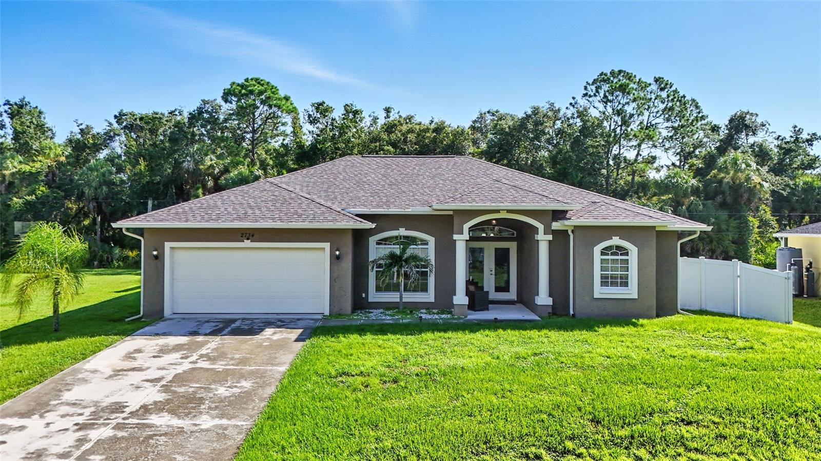 Welcome to this beautifully maintained 3 bedroom, 2 bathroom pool home located in a quiet and convenient neighborhood of North Port, offered TURN-KEY! Situated on a spacious lot this property combines comfort, charm, and recent updates that make it truly move-in ready. Step inside to a warm and inviting sitting area that welcomes you into the home, followed by a generous entryway featuring built-in shelving and a formal dining area that adds both character and functionality. The open-concept floor plan seamlessly connects the kitchen, dining, and living spaces, making entertaining a breeze. The eat-in kitchen boasts a breakfast bar, stainless steel appliances, and a view that opens directly onto the covered lanai and screened-in (caged) pool—perfect for enjoying Florida living year-round. Whether you're relaxing poolside or hosting friends, this large fenced backyard is ready for it all. A brand new pool pump (2025) also ensures worry-free enjoyment for years to come. The primary suite is a private retreat, with sliding glass doors leading directly to the lanai, and an ensuite bathroom featuring custom cabinetry (2023), dual vanities, a large soaking tub with beautiful stone accents, and ample space to unwind. Additional updates include NEW FLOORING in the bedrooms (2023), a new REVERSE OSMOSIS system, and a brand NEW WELL installed in 2025, ensuring reliable water service and efficiency. Situated in a peaceful residential area of North Port, this home offers quick access to shopping centers, restaurants, and the newly developed Wellen Park. You're just a short drive from Gulf Coast beaches, A WATER PARK at North Port Aquatic Center and a variety of parks and outdoor activities, making it the perfect place to enjoy both convenience and nature. Don’t miss this opportunity to own a beautifully upgraded pool home in one of North Port’s most desirable locations!
