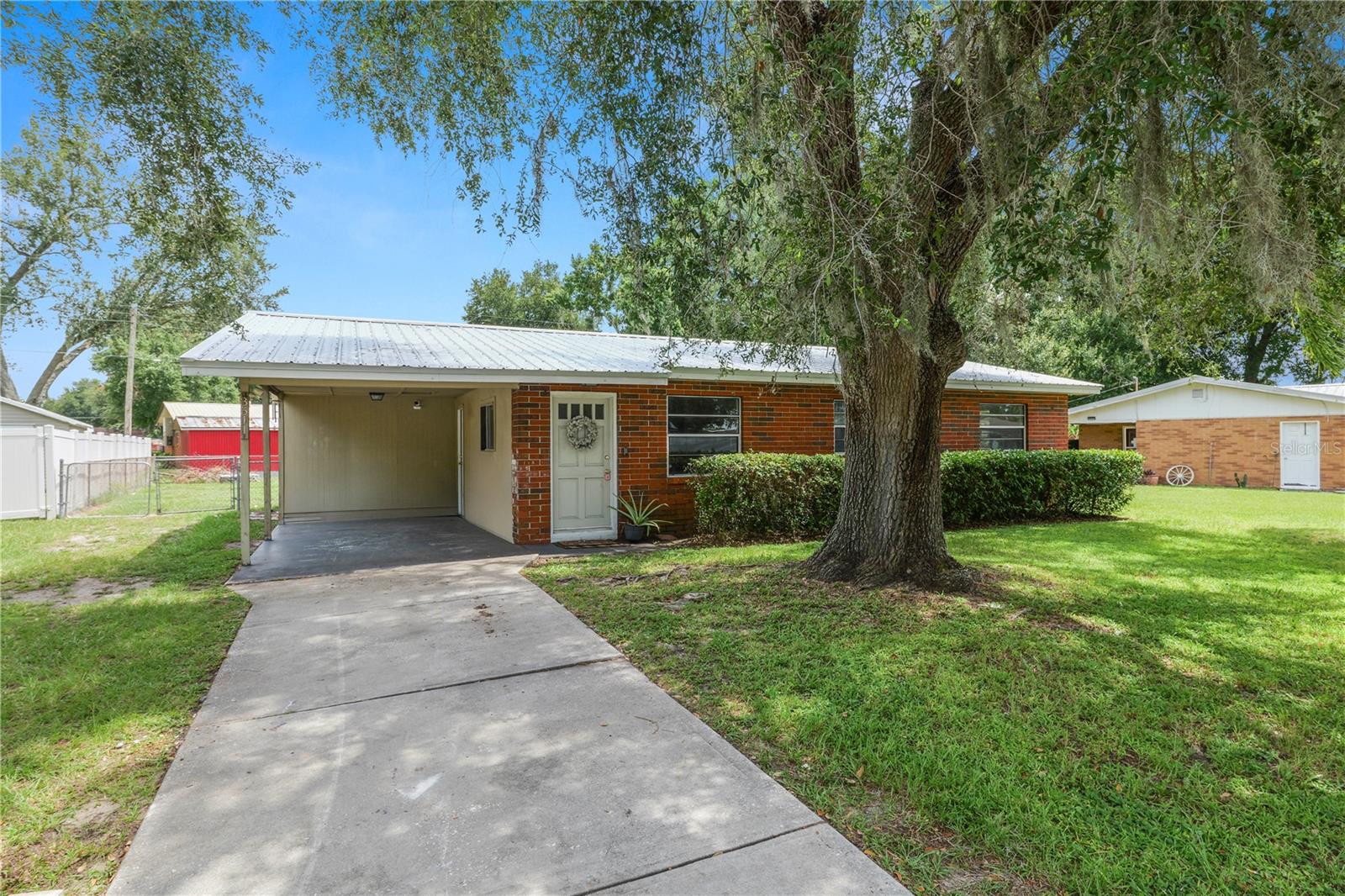 Under contract-accepting backup offers. Welcome to this beautifully updated 3-bedroom, 1.5-bath block home located in the quiet Winston area of North Lakeland – with NO HOA! This move-in ready property offers modern upgrades throughout including new paint, renovated kitchen with granite countertops, shaker-style cabinets, and more. The spacious living area flows into a versatile 360 sq ft enclosed sunroom under central A/C – perfect for a home office, playroom, or second living space. Enjoy comfort and peace of mind with a newer HVAC system (2020), updated electrical panel (2018), attic insulation, cameras that will convey. The home sits on a large, fully fenced quarter-acre lot featuring a storage shed and carport with direct access to the kitchen. The main bathroom has been refreshed, and the master includes a private half-bath.
Solid block construction with brick accents, a great layout make this home a standout. Located minutes from shopping, schools, and I-4 for an easy commute to Tampa or Orlando. ACCEPTING FHA