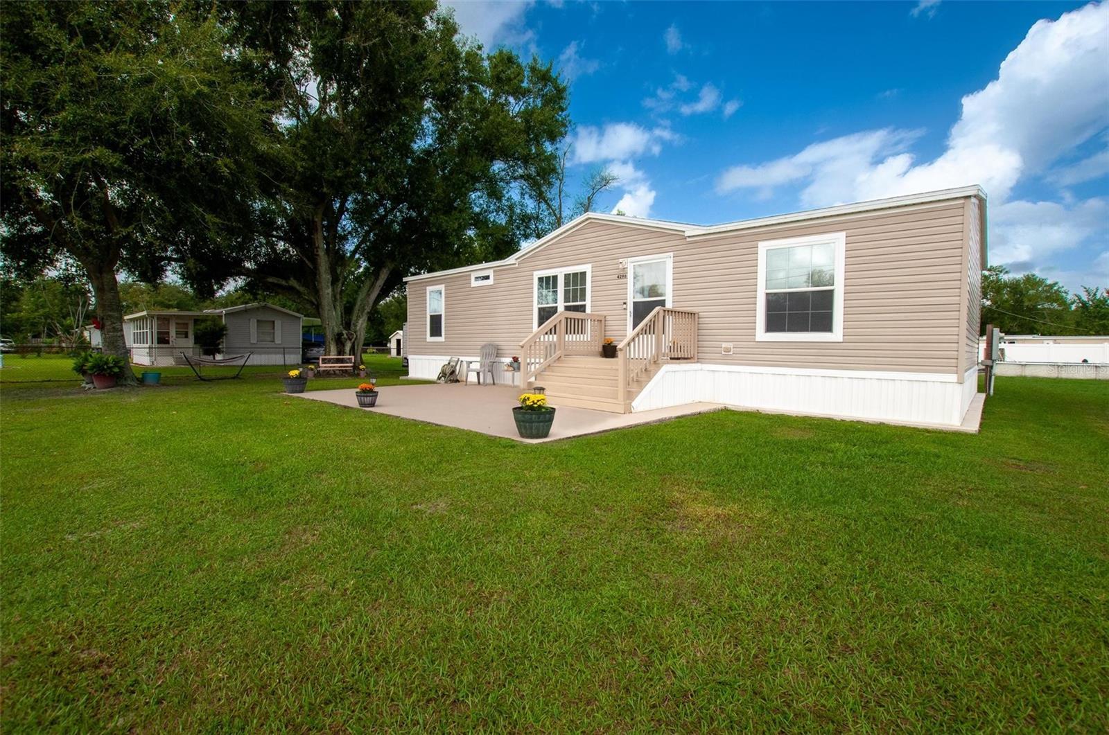 Looking to live just beyond the city limits while still being close to all the conveniences you need? This beautifully maintained 2017 “Amelia by Champion” manufactured home offers the perfect balance of privacy and accessibility, sitting on nearly half an acre in a central location.Inside, you’ll find 3 bedrooms and 2 bathrooms in an open-concept split floor plan that maximizes both space and comfort. The kitchen is a chef’s delight with stainless steel appliances, abundant cabinetry, a pantry, and a center island—perfect for cooking or gathering with friends and family. Just off the kitchen is a dedicated laundry/utility room with direct access to the backyard.The bedrooms are generously sized, with the primary suite featuring a spacious walk-in closet and a luxurious ensuite bath. Recent updates add to the home’s appeal, including new LVP flooring in the living room, primary bedroom, and one guest bedroom, fresh paint, and a new water heater.Step outside to enjoy concrete patios in both the front and back, as well as a concrete mow edge around the skirting for easy maintenance. The fully fenced property features chain link around the perimeter and brand-new white vinyl fencing for extra privacy while you swim and relax in the fabulous above-ground pool. An 8x12 storage building is also included, providing excellent multifunctional storage space.Don’t miss the chance to see everything this beautiful home has to offer—schedule your showing today!
