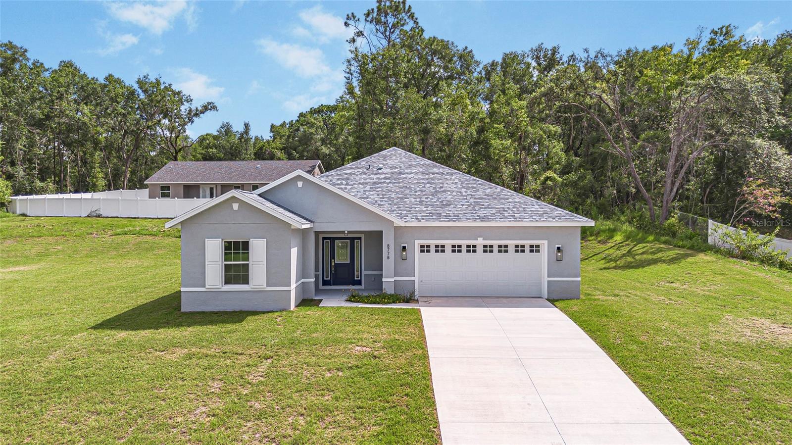 Enjoy the difference that award-winning quality makes in this stunning Citrus Springs home. Beautifully designed with meticulous attention to every detail. This split open floor plan features soaring 9 foot tray ceilings. A dream kitchen with sleek quartz countertops, upgraded soft close cabinets (pull out spice cabinet and cookie pan drawer) and a fabulous walk in pantry. Throughout the main living areas, you'll find durable luxury vinyl planking, offering both beauty and easy maintenance. Unwind in your primary bedroom retreat, complete with an ensuite bathroom and walk-in closet, offering your own sanctuary. Practicality meets convenience with an inside laundry room and a double-car garage. There's no HOA! Embrace the Florida outdoors with Citrus Springs 18-hole golf course being literally around the corner, hike/bike the Withlacoochee Trail, kayak or float down the crystal clear waters of the Rainbow River – it's all practically on your doorstep!