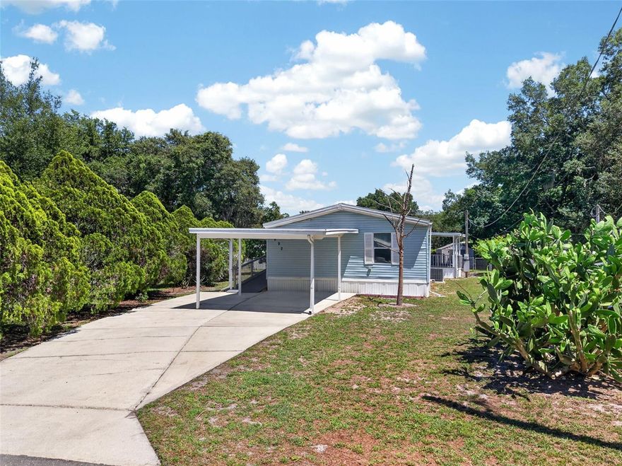 One or more photo(s) has been virtually staged. SEE THIS QUICKLY!  This 3BR/2BA mfg home located in SE Winter Haven is in a NO HOA neighborhood with lake access, has a NEW ROOF in 2023, NEW HVAC 2024, and it has been REPIPED.  This is an open floor plan with large bedrooms that all have walk in closets, vaulted ceilings, an inside laundry with included LG front load washer and dryer, a spacious kitchen, separate dining room and a huge great room!  Accessibility improvements have been made with the remodeled master bathroom including a large shower,  along with a comfort height toilet and grab bars which are in both bathrooms. Outside there is an access ramp, a carport for covered parking, two utility buildings and a fenced backyard.  There is a good sized porch with plenty of room for a grill and to enjoy relaxing. Located on a cul-de-sac there is no thru traffic.  SE Winter Haven is close to LEGOLAND, Highway 27, shopping, dining, medical, schools and more.