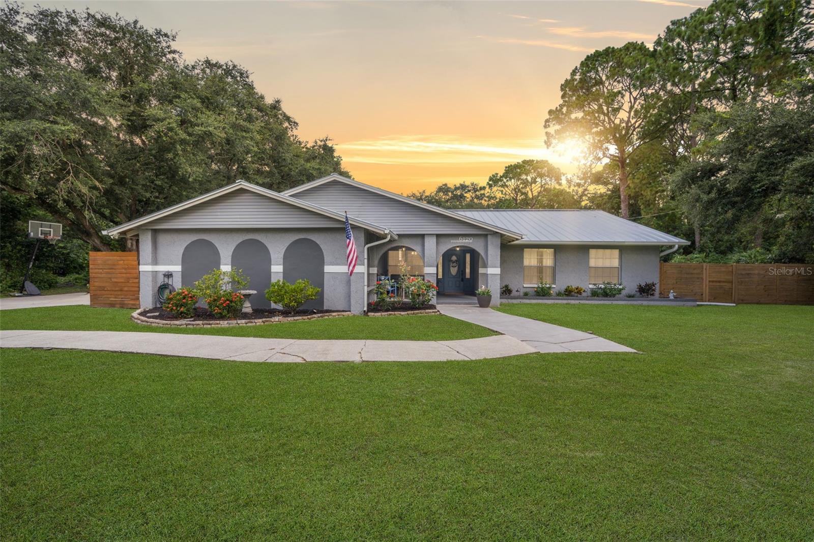 This impressive home features four bedrooms and three bathrooms, offering over 2,300 square feet of living space. It boasts distinct areas, including a separate living room, family room, and formal dining room. Recent upgrades enhance its appeal, such as an inground saltwater pool added in 2022, a metal roof installed in 2019, and a new HVAC system and electric hot water heater both installed in 2024. Situated on more than an acre of land, the property includes a two-car side-entry garage, a separate two-car carport, a shed with electricity, and even a charming treehouse. Additionally, a spacious covered screened porch provides a perfect spot for relaxation. This home is in excellent condition and awaits its new owner.