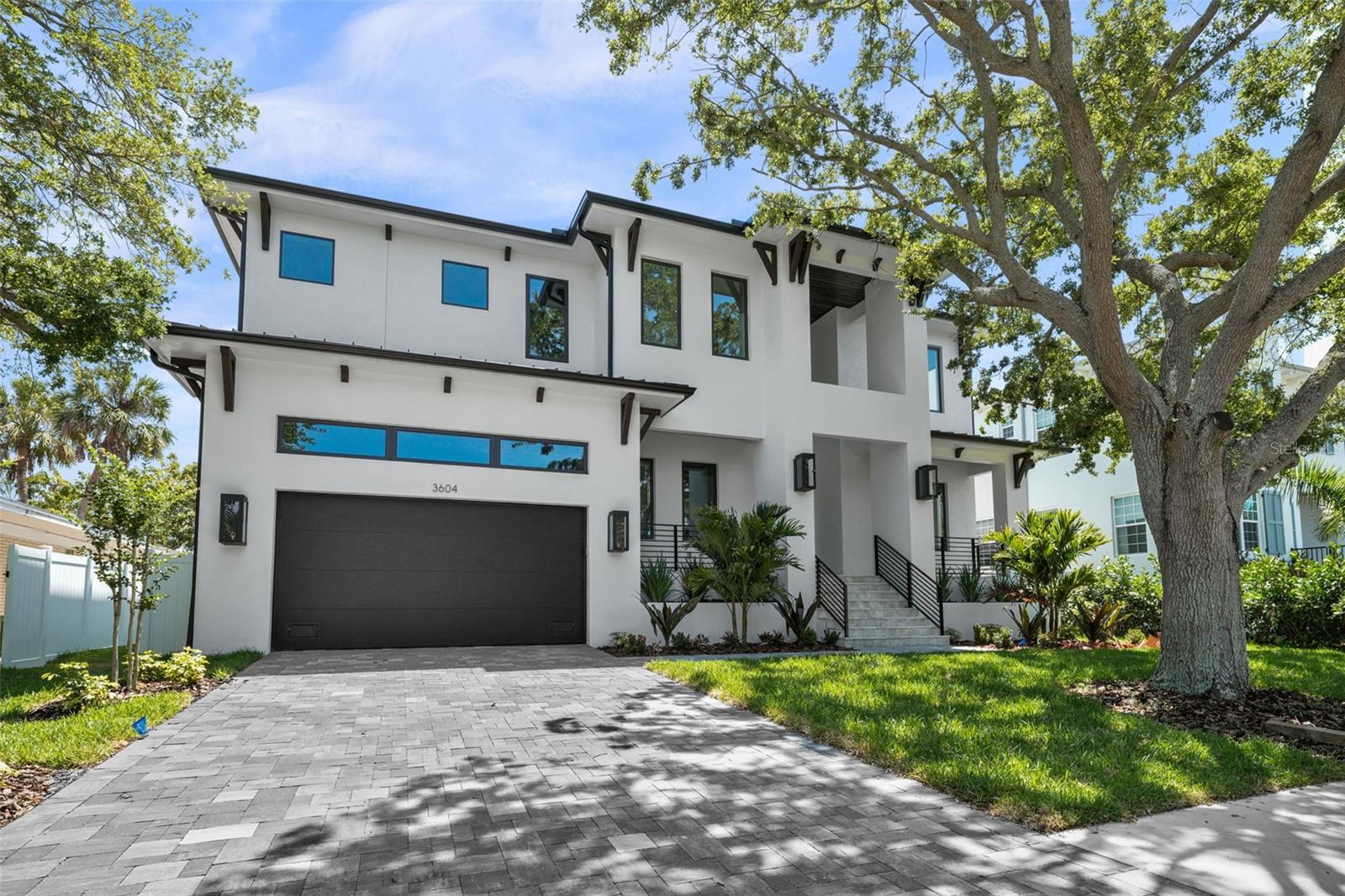 Introducing a newly constructed pool home by Baywalk Custom Homes in Bel Mar Shores. This residence showcases exceptional quality and craftsmanship, boasting stunning high-end finishes and an open floor plan. Spanning over 5,800 square feet, this home offers 5 bedrooms, 6.5 bathrooms, a bonus room, and a den, ensuring ample space for everyone. On the first floor, you'll find a large guest suite with a private bath, an office/den, a formal dining room with a buffet and intricate ceiling details, and a spacious gourmet kitchen. The kitchen features a large island, a walk-in pantry, oak veneer cabinets, Thermador stainless steel appliances, a 48" built-in fridge and range with a double oven, marble countertops, and an adjacent breakfast nook. The kitchen opens to a grand family room with a gas fireplace surrounded by striped ceramic, and large pocket sliding glass doors leading to a spacious lanai with an outdoor kitchen. Additionally, there's an oversized 4-car garage, ready for a car lift to hold up to 8 cars, with an adjacent mudroom and secondary laundry space. The second level includes a large game room with a half bath, three secondary bedroom suites each with walk-in closets, and a lavish primary suite. The primary suite features a free-standing bathtub, a shower with multiple shower heads, limestone floors, marble walls, and generous his and hers walk-in closets. The upstairs also has a large laundry room with cabinetry and a sink. Additional features include large plank wood floors throughout the home, upgraded tile in all wet areas, 10-foot ceilings, a pool and spa, and much more.