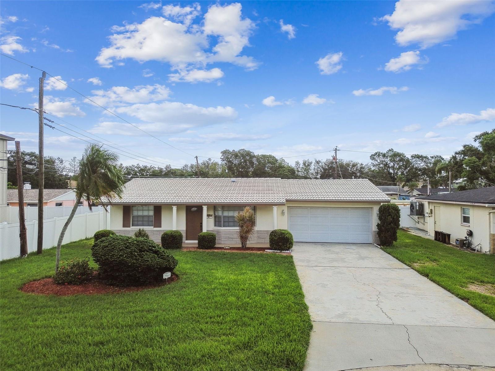 One or more photo(s) has been virtually staged. FLORIDA DREAM HOME! This impeccably renovated (and lovingly cared for by one owner) home features three bedrooms, two bathrooms plus a two car garage is set on a quiet cul-de-sac on an oversized lot (10,237 Sq Ft) in the desirable Riviera community. Newly remodeled in 2025, this one story home with a split floor plan blends modern comfort with elegant design style and features highly desired sturdy block construction along with a durable concrete shingle roof that can easily handle the Florida weather! Entertain family and friends in the beautifully designed, newly remodeled kitchen showcasing new cabinetry, new quartz countertops, a convenient new center island, gleaming all new Stainless Steel Appliances (GE Gas stove, Frigidaire refrigerator, Frigidaire dishwasher, and a Samsung microwave). The light and bright kitchen opens up to a screened in porch for an additional entertainment area perfect for dining al fresco and the large backyard adds to year-round versatility. The tranquil primary bedroom includes a newly remodeled, well appointed ensuite bathroom with designer tile walk in shower, new vanity, toilet, and fixtures. Rounding off the floor plan includes two comfortable size bedrooms with spacious closets and a second newly remodeled guest bathroom with new tub, vanity, toilet, and fixtures. The backyard is the perfect canvas to make it your own private oasis with room for a pool and has a reclaimed water Irrigation system for the entire property to keep everything green! Park your car safely in the two car garage with fresh epoxy coating. The new Larkmead Oak Wood laminate flooring in main living areas and bedrooms is designed to be waterproof and scratch resistant. . Additional upgrades include a hurricane impact garage door, gas water heater (2025), new air conditioning condenser (2025), A/C Handler (gas) 2015. Gas hookup for a dryer available. Electrical box upgraded in 2020. This lovely home is being offered with a Home Warranty. Located just off the thriving 4th St N corridor with quick access to 275 for easy travel to downtown St Pete, Clearwater, the Beaches, and Tampa.