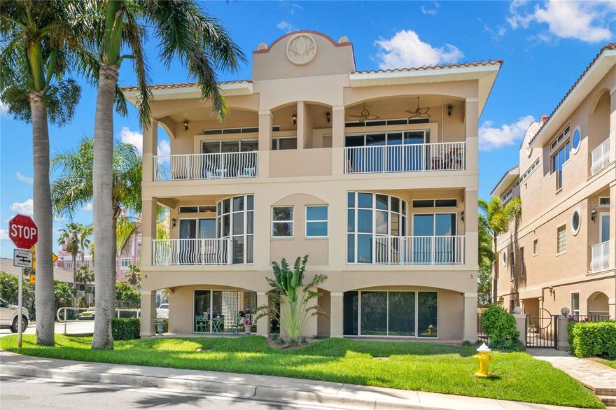 Located on the corner of Perfection and Paradise!  This incredibly positioned townhome is just two blocks to the white sugar sand beaches of the world-renowned St. Pete Beach and the Historic Don Cesar Resort Hotel.  With deeded waterfront dock and boat slip on the Intracoastal Waterway and Dedicated Neighborhood Beach Access, you have the best of both worlds for Boating and Sunbathing.  The private Rooftop Deck has stunning views of the Intracoastal, Boca Ciega Bay and the Gulf of Mexico.  The third level has open concept Living Room with views of the Bay and sliding doors on the sunrise side, a beautifully appointed kitchen with Kohler fixtures, Kitchenaid appliances, breakfast bar, built-in desk and pantry, and the dining area with floor to ceiling windows looking west toward the Don Cesar and the Sunset Sky!  The second level has three bedrooms, all with ensuite baths.  The Primary Suite has Intracoastal views and sliding doors to a private balcony for morning meditation, two walk-in closets and a full bath with jacuzzi tub, separate shower, double vanity and private water closet.  Laundry is also located on this level.  The First Level of this corner townhome has a foyer with side entry and private elevator servicing all three floors, a large bonus room, perfect for fitness area.  Sliding doors from the bonus room open to a covered lanai and the waterfront with deeded dock and slip.  This residence has an attached two car garage.  A small community pool is tucked into a gated courtyard for ultimate privacy.  Additional features include concrete construction, security and intercom, CAT5 and surround sound wiring, solid wood cabinetry, granite countertops and custom closets.