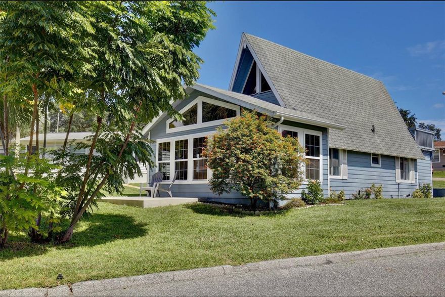 Beautifully UPDATED Vacation Village home in a quiet LAKEFRONT COMMUNITY with its own PRIVATE BOAT RAMP to Lake Louisa. This 2-bedroom, 2-bathroom home features tastefully modern updates throughout the home. The main level creates an inviting, well decorated space with laminate and tile floors. A spiral staircase leads to the second bedroom loft with direct access to a private patio/balcony to soak in the fresh air and Florida sunshine. Additional features include a full-size washer and dryer in the laundry area off the Primary Suite. Vacation Village offers an incredible array of amenities covered by the monthly HOA fees, including an Olympic-size swimming pool, tennis, pickle ball, shuffleboard and basketball courts, a car washing station, multiple playground areas, private beach access to Lake Louisa via the community lakefront lot, a private community BOAT RAMP and DOCK, plus a fenced oversized parking area for RVs, vehicles, and boats for a small monthly fee. Live here full-time or part-time, rent long-term or short-term, or let the front office property managers handle bookings for you and simply collect the income. HOA fee also covers exterior maintenance such as roof and siding, lawn care, cable, Wi-Fi, water, sewer, trash, pest control, termite protection and common area amenities. New Roof October 2025. Just minutes to everything you need, including groceries, shopping, medical care, entertainment, and dining, with Universal Studios, and Walt Disney World less than 30 minutes away. Unit is sold fully furnished. Come check out this amazing home and experience everything Vacation Village Resort has to offer!