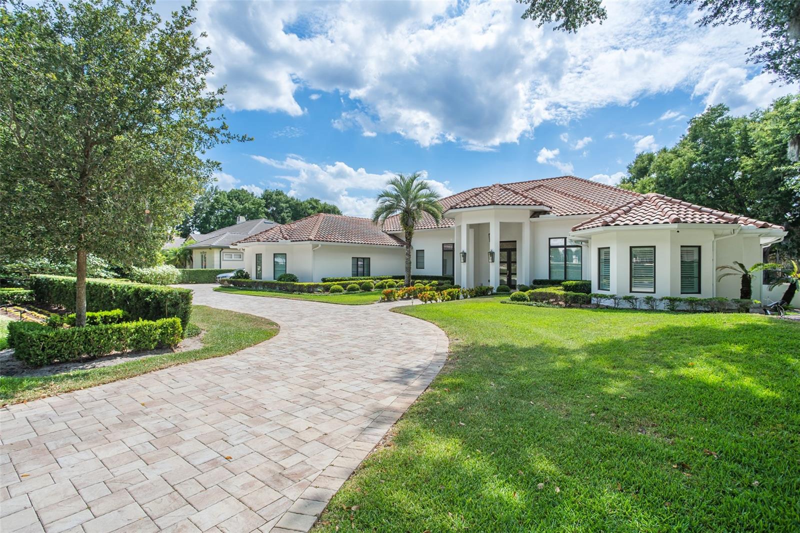 Experience luxury living in this stunning, modern estate situated on the renowned Isleworth Country Club Golf Course, overlooking the scenic hole 6. This exquisite home offers the finest in contemporary design and high-end amenities, providing a perfect blend of elegance and comfort. The updated, modern, chic 4,225 square-foot home boasts four bedrooms and four bathrooms along with spacious, open-concept living and dining areas. High ceilings with large windows offer abundant natural light and panoramic views of the golf course. The gourmet kitchen is equipped with top-of-the-line appliances, custom cabinetry, and a large island with seating; along with modern fixtures and finishes, including quartz countertops and designer lighting. A sparkling pool, expansive patio with seating, dining area, and a custom fire pit round out the property with the ideal outdoor gathering space on a magical golf front oasis.