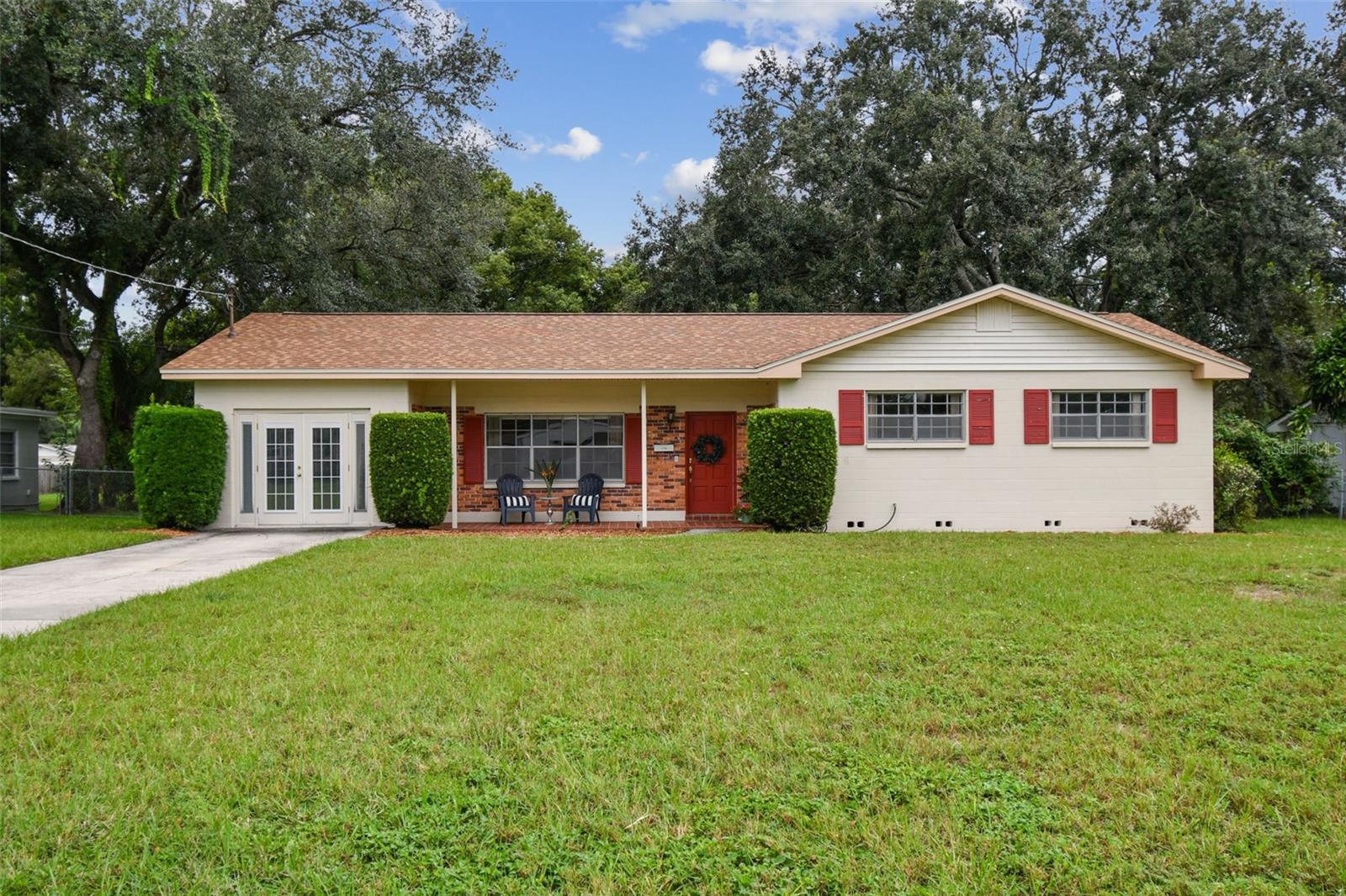 Welcome to your new home in Forest Hills! This 3 bedroom, 2 bathroom home offers 1,262 sq. ft. of living space on an amazing ½-acre lot shaded by beautiful, mature oak trees. A true diamond in the rough, this property is full of potential and ready for you to transform into your dream home!
Inside, you’re greeted by a sun-filled living room with gleaming laminate floors that flow seamlessly into the dining area — an inviting space for everyday living and entertaining. French doors open to the patio, creating a natural transition to outdoor living, ideal for hosting, gardening, or simply enjoying the serene, park-like setting.
The kitchen includes a convenient bar for extra seating, while a perfectly placed window frames views of the amazing backyard. Just off the kitchen, a large laundry room provides plenty of storage and added functionality.
The primary bedroom features a private bathroom and spacious closets. Warm hardwood floors make it a cozy retreat where you can relax after a long day. Each of the additional bedrooms also offers hardwood floors and generous closets, creating flexible spaces for family, guests, or a home office. The bathrooms still have the vintage tile work that allow you to integrate the original character with your own modernized features.
The expansive backyard is more than large enough to add an ADU or casita — the perfect opportunity for an income-producing rental, guest house, or private in-law suite.
The location is hard to beat — just a short walk to Babe Zaharias Golf Course with its Pro Shop, Clubhouse Restaurant, and community events. You’re also minutes from Busch Gardens, Lettuce Lake Park, ZooTampa, USF, and just a quick drive to Downtown Tampa.
Don’t miss this opportunity to make a Forest Hills gem your own. Schedule your private showing today!