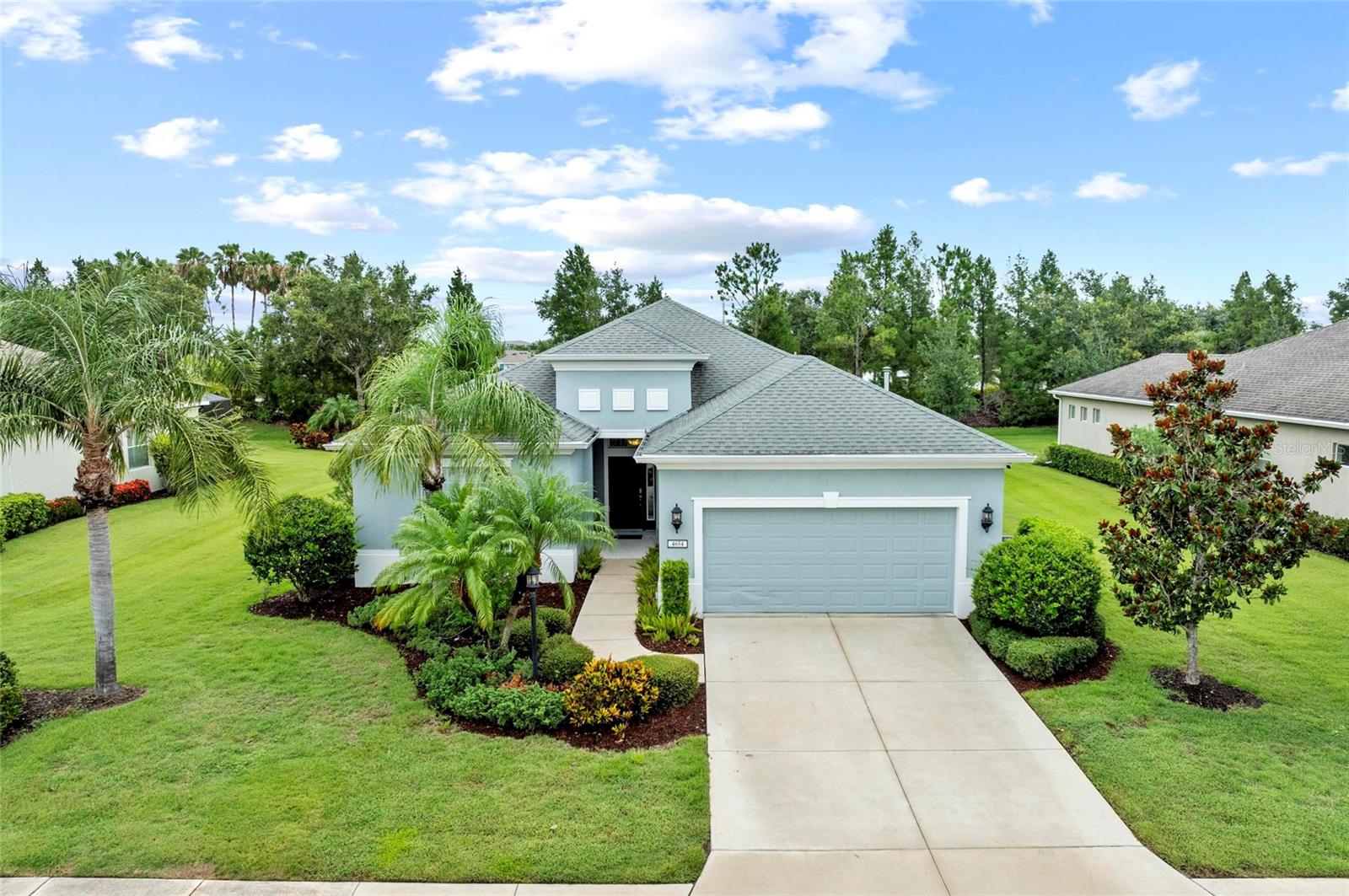 Welcome to Central Park in Lakewood Ranch—a vibrant, family-friendly community perfectly located just steps from Gullett Elementary and Mona Jane Middle School. This Neal-built home is ideally situated on a premium oversized lot with no rear neighbors and a peaceful, open view across the street, offering exceptional privacy and a picturesque setting that’s hard to beat.
Located in one of the most desirable sections of Central Park, this home is part of a private, separately gated enclave that includes exclusive access to a community pool and fitness center.
Boasting nearly 2,500 square feet under air, the home features 3 bedrooms, 2.5 bathrooms, a large office/den, and an oversized 20x26 two-car garage. The open-concept floorplan flows effortlessly, with a spacious kitchen overlooking the great room and a charming breakfast nook with built-in seating. A beautiful tray ceiling adds elegance to the great room, enhancing the open and inviting feel.
Interior highlights include hardwood floors in the great room and dining area, carpet in the guest bedrooms, and laminate flooring in both the primary suite and office. The primary suite is tucked away at the rear of the home, offering direct access to a private covered lanai with a remote-controlled electric screen—perfect for enjoying Florida evenings without the hassle of traditional screens.
Additional features include a utility room with laundry sink and a brand new A/C system for peace of mind.
Central Park is known for its gated entrances, dog parks, splash pad, tennis courts, and scenic walking trails—all while being just minutes from shopping, dining, I-75, and downtown Sarasota.
Don’t miss your opportunity to call this exceptional home your own. Schedule your private showing today!