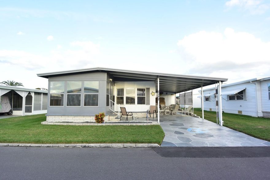 Welcome to beautiful Lake Conley Mobile Home Park in Holiday, Florida! This turnkey 2-bedroom, 2-bath doublewide is tastefully decorated and offers all the right updates to make your winter getaway or year-round Florida dream a reality. The home features an open-concept layout with an updated kitchen (2017), subfloors and laminate flooring (2018), HVAC system (2020), custom acrylic driveway (2022), new electrical panel (2023), new skirting (2024), and a freshly power washed & painted roof with a new vent (2025). Additional upgrades include a new dishwasher and mailbox (2025). Enjoy relaxing in the enclosed front porch with a lovely water view, plus a one-car carport and attached utility room for added convenience. Lake Conley is a beautiful lakefront, gated community offering a clubhouse, pool, shuffleboard courts, an active event calendar, community dock and boat ramp, and optional boat/RV storage (subject to availability for a fee)—all for a super low monthly fee. Conveniently located near the world-famous Tarpon Springs Sponge Docks and just 40 minutes to Tampa International Airport, this gem won’t last long—schedule your showing today and start living the Florida lifestyle you’ve been dreaming of!