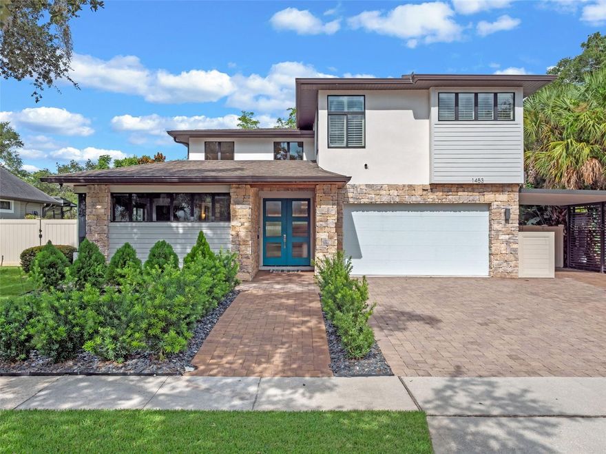 Welcome to this updated and architecturally unique 5-bedroom, 3.5-bathroom custom home, offering 3,292 square feet of luxury living in the heart of Winter Park. Step inside and you’re immediately greeted by gleaming porcelain tile floors, smooth modern non-textured walls, and soaring ceilings that create a light and airy feel. The spacious living room features custom wall details, crown molding, an elegant wine cellar with glass wall, and expansive high windows that flood the home with natural light. Glass accents continue throughout with an updated staircase and second-level glass wall, adding a sleek, modern touch. To the left, discover a rare double-primary suite layout. A converted study now serves as a second primary bedroom, connected by a hallway with two walk-in closets. The shared spa-style primary bath includes dual vanities, a hot tub, and a glass shower. The suite on the west side enjoys private access to the pool area. Both bedrooms have tray ceilings with crown molding. The open dining area flows seamlessly into the kitchen, which showcases a natural gas range with pot filler, a large island with seating, pendant lights, granite counters, stainless steel appliances, and a unique indoor-outdoor service window that opens to the summer kitchen. The first floor is completed with a third bedroom (currently used as a home office), a full bath, and a laundry room. Ascend the glass-accented staircase to the second floor, where you’ll find a versatile dining/bonus room with porcelain tile flooring and tray ceiling, a kitchenette and a balcony overlooking the pool. Two additional bedrooms, a full bathroom, and a spacious storage closet complete the upstairs. The outdoor space has been completely reimagined for entertainment and relaxation. Enjoy a
heated pool and spa with water features and stonework, outdoor shower, summer kitchen with bar seating, pergola, artificial turf, and plenty of yard space. The backyard is fully fenced and includes a storage building with a half bath. A whole-home 24kW Generac generator provides peace of mind. Additional highlights include a two-car garage, a carport for extra parking, and a prime location just minutes from Park Avenue’s upscale shopping and dining, Whole Foods, and easy access to major highways. This exceptional Winter Park home blends custom design, modern updates, and outdoor luxury. Schedule your private tour today.