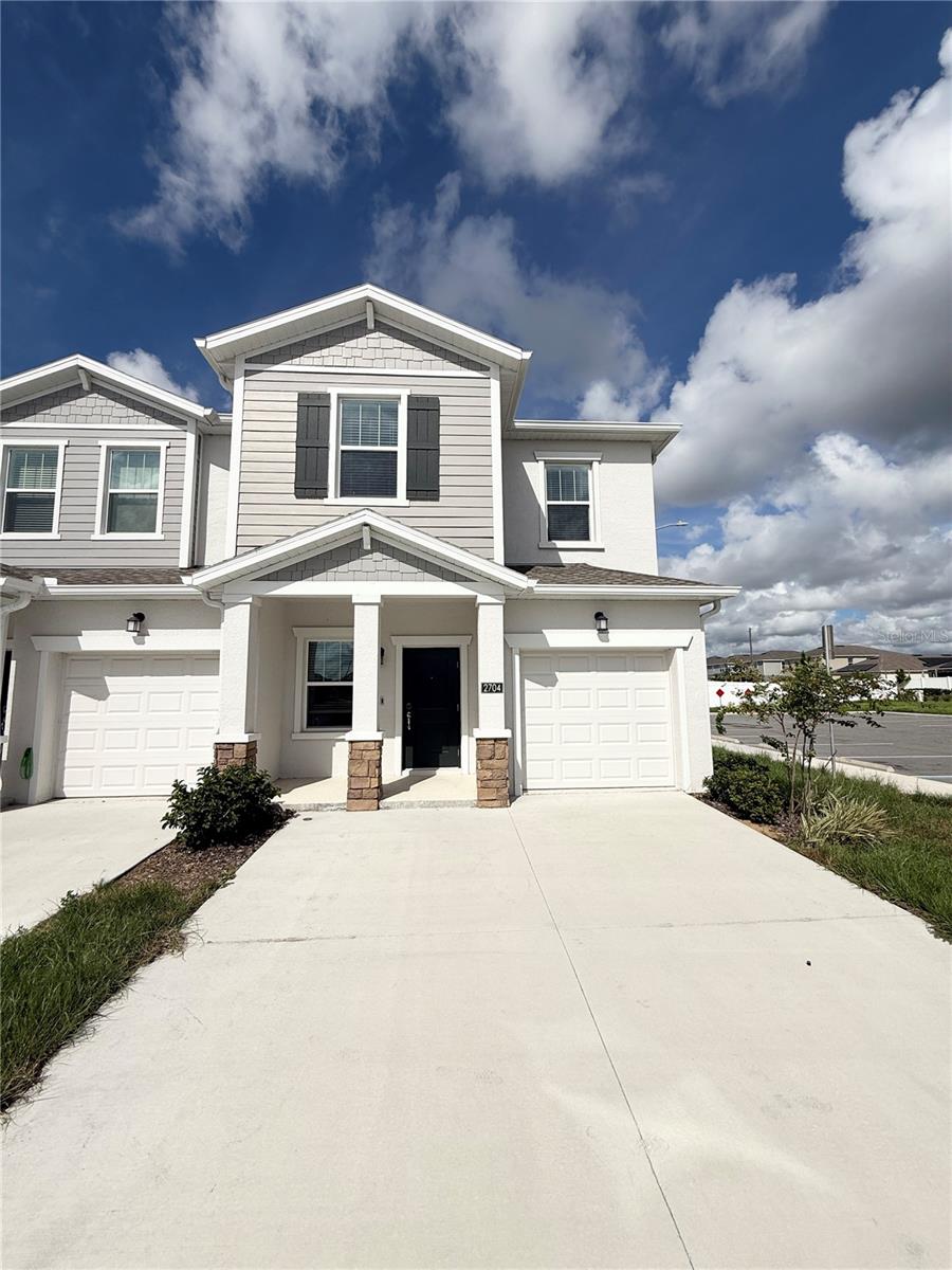 Why wait to build when you can own this never-lived-in, beautifully designed two-story former model home? As an end unit, it is filled with natural light and offers a thoughtfully crafted layout. A versatile flex space flows seamlessly into the modern kitchen, featuring 42" upper cabinets, quartz countertops, stainless steel appliances, and an open Great Room—perfect for everyday living and entertaining. Sliding glass doors lead to a covered lanai, creating an effortless indoor-outdoor lifestyle.
Upstairs, two spacious secondary bedrooms share a full bath, while the private owner’s suite is tucked away for comfort. The suite includes a double-sink vanity, large walk-in shower, and generous walk-in closet.
This community is situated in a rapidly growing area with excellent shopping and dining just minutes away at Posner Park. Conveniently positioned near I-4 and Highways 27 and 17, it offers seamless access to all that Orlando has to offer. Plus, Walt Disney World Resort is only 10 miles away, placing world-class entertainment right at your doorstep.