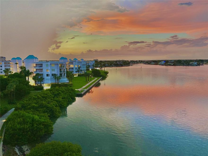 One or more photo(s) has been virtually staged. UN-OBSTRUCTED VIEWS from this Luxurious waterfront fifth-floor condo. Breathtaking views of Bogus Ciega Bay, nestled in a guard-gated island community with 24-hour security. This residence invites resort-style living at its finest, with expansive floor-to-ceiling windows and private balconies that frame panoramic water vistas, inviting the outdoors in and expanding the living space. The open-concept layout flows gracefully from a gourmet chef’s kitchen, outfitted with premium appliances, quartz countertops, and custom cabinetry, to the elegant living and dining areas anchored by designer finishes and refined millwork, private balcony off the kitchen is the perfect nook for enjoying your morning coffee.The primary suite is a tranquil retreat, featuring serene water views, a spa-inspired ensuite, and generous. must-see custom made closet, while an additional bedroom offer comfort with an updated full guest bath with glass enclosed shower and lavish tile work.The gleaming Floors throughout blends seamlessly with the indoor-outdoor connectivity, and the space is highlighted by newly painted walls and ambient lighting that complement a coastal, resort-inspired aesthetic. Residents enjoy resort-style amenities within the community, pickelball, tennis sauna,a pristine pool, state-of-the-art fitness center, and a landscaped promenade—along with private elevator access for convenience and security. An in-unit laundry room, ample storage, assigned covered parking, guest parking, and nearby upscale dining, boutique shopping, and cultural attractions enhance the sophisticated Florida lifestyle. Short drive to the sugary white sands of St Pete Beach. Easy access to waterfront leisure activities completes the pinnacle of worry-free luxury living, supported by impeccable maintenance and 24/7 on-site management. Come live your Florida Dream today.