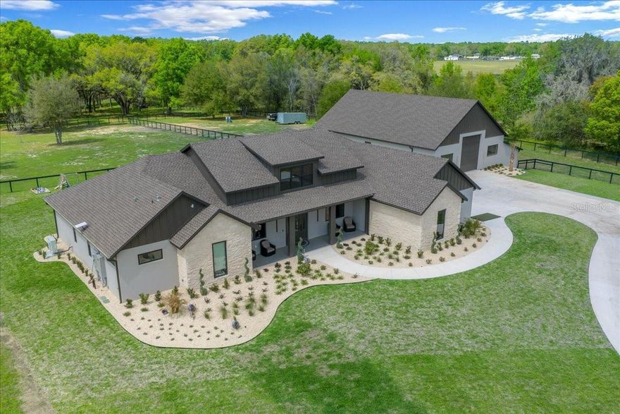 The Heart of Horse Country is offering a Breathtaking Custom Gated Equestrian Estate within minutes of The World Equestrian Center. Newly constructed, the residence rests a top 10 acres offering timeless architecture, modern elegance and the highest quality of construction and finishes. With over 3800 square feet with 4 bedrooms, 5 baths, plus a den. in a multiple split layout arrangement for privacy.  The living areas and kitchen create spaces for seamless entertainment inside and out. The gourmet kitchen is designed for beauty and function, featuring rich custom cabinetry and a massive island, dual refrigerators, double ovens and a complete beverage center. The kitchen is appointed with Z LINE appliances with champagne accents.  The private primary retreat features an adjacent sunroom, dual vanities, walk in rain shower, custom closet cabinetry with private laundry facilities.  Two guest bedrooms and bathrooms on the main level with a 3rd upstairs creating a studio retreat.  The laundry room has direct access from the barn and offers an arrival center, additional custom storage cabinetry and wine storage.  The first level of the home is entirely porcelain tile and the studio has wood flooring.  The upstairs studio retreat offers guest a private space and incredible farm views.  The maintenance barn is 56 x 64 offering a very versatile space. for recreational vehicles, maintenance equipment and includes both interior and exterior stalls. and additional interior stalls. Included in the barn is an office with a kitchenette, bathroom and laundry facilities. The office is 450 square feet The barn is entirely constructed of block, offers two 14’ roll up doors, spray foam in the ceiling with tongue and groove ceiling and can easily accommodate additional interior stalls.  Construction features include block construction, energy efficient spray foam insulated ceilings in both the home and the maintenance barn, stone accents,  Anderson Windows throughout, Custom Cabinetry throughout, Quartz counters, 8’ doors throughout, tongue and groove soffits  Farms features include a gated entry, 900’ entry drive, 26KW whole property generator with 250 gallon propane tank and an advanced well system providing consistent pressure throughout the property.  Future expansion is an option with arena space available and additional 10 acres is available for purchase.