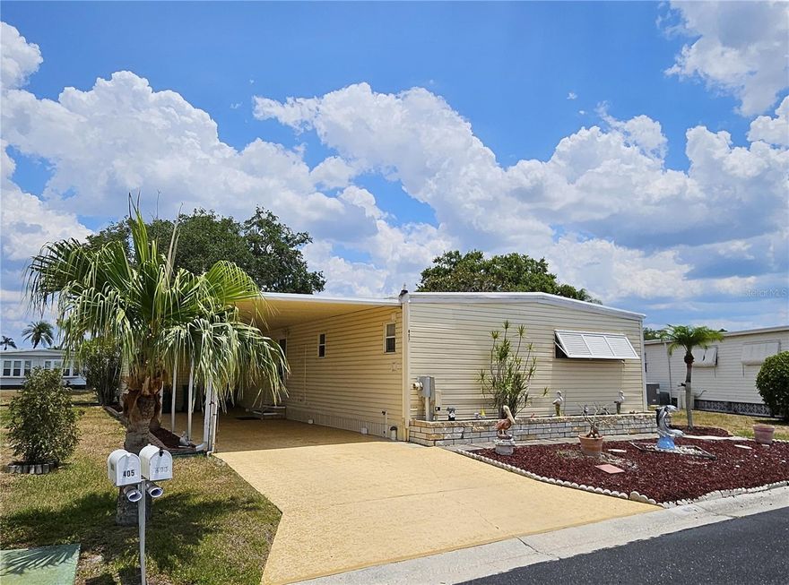 Great Price for Waterfront home located in the ONLY Resident Owned Park in the City limits of Sarasota!! 
This 2 bed 2 bath gem is waiting for you to put your personal touch on it. The kitchen has tile flooring, a decorative tile backsplash, updated cabinets and counters giving plenty of storage and counter space, 2 pantries, a flat top stove and a dishwasher have been added. Just off the kitchen is a space suitable for a breakfast table or desk/work area. The living room is accessible from the kitchen and has sliders leading to the lanai where you can enjoy views of the sunrise overlooking the water. The lanai also has access to the carport and a convenience ramp, 2 ceiling fans, a wall unit AC ( not sure if functioning) and newer hurricane shutters. The formal dining space is accessible from the kitchen and living room. The primary suite has a roll top desk, walk in closet and an updated en suite bath with step in shower additional storage closet and a built in safe. The guest bedroom has a double bed, dresser walk in closet and is just across from the full size bath with a shower/tub with tiled walls and high vanity. The storage shed houses the washer, dryer, utility sink, water heater, and has been enlarged to 190sf providing ample space for storage. Home is partially furnished, both bedrooms have escape doors. Home is partially furnished. Oakwood is a 55+ / no pet / no motorcycle park.

Original updates include: Kitchen, Baths, AMS roof over 2000, carport elastomeric RO, HVAC 2014 3ton with 2 UV lights, water heater 2017 38gal housed in shed, vinyl windows on lanai 2001 and newer hurricane shutters for lanai, windows on home updated 2001 single pane, vapor barrier 2010, 10 tiedowns added 2010, plumbing is pvc and copper with shutoffs, sewer line 2010, sub panel in shed is updated Sq D, built in large safe, 

The gated 90 acre community boast low maintenance fee with its vast amenities starting with the large Clubhouse outfitted with a full commercial cook kitchen, event stage, audio/visual, dance floor, fitness room, activities hall, library with books/movies/puzzles and a pool table. Outside recreation includes an extra large heated pool with a handicap ramp, a spacious kidney shaped hot tub, ample tables and lounge chairs and remodeled shower rooms. Oak trees shade the beautiful park area, picnic tables and a community grill. Additional amenities to enjoy are the community putt putt course, bocce ball, ping pong, horse shoes and corn hole. Oakwood Manor is a highly social community with many groups and activities to be a part of. We are located adjacent to Legacy Trail and 12 new pickle ball courts managed by the City.  Close to downtown, shopping and dining. Please note that Oakwood is a NO pet and NO motorcycle Park.