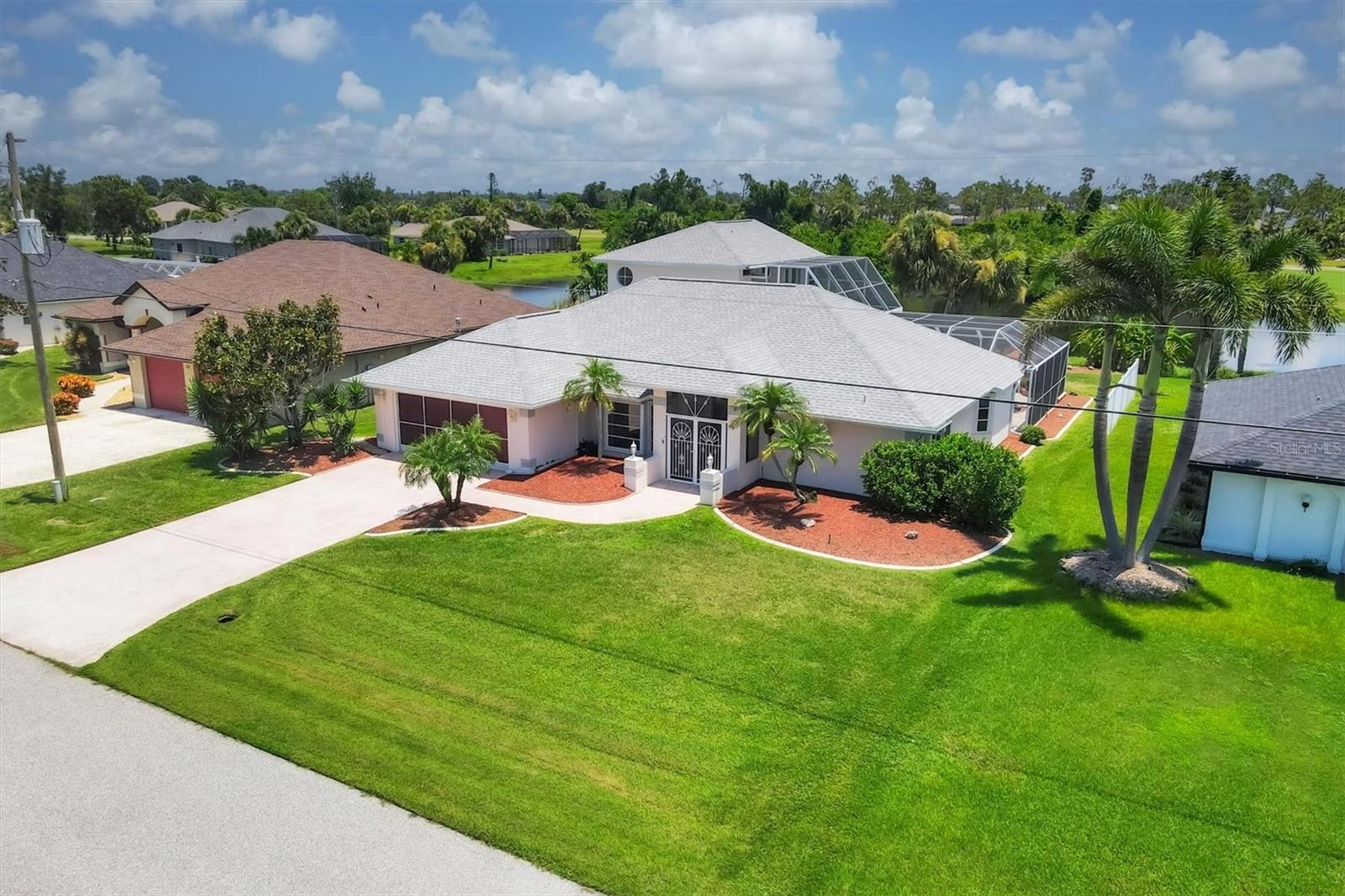 Discover a truly unique and spacious home in the heart of Rotonda West, set on a beautifully landscaped property with serene pond views. This 4-bedroom residence offers a thoughtful split-bedroom layout with the primary suite conveniently located on the main floor—and a rare bonus upstairs secondary master suite, accessible by an indoor elevator and has it's own private exterior balcony! This versatile space could easily serve as an in-law suite or private guest retreat.
From the moment you enter, you’re welcomed into a formal living and dining area that flows seamlessly to the lanai through pocket sliding glass doors, framing views of the sparkling pool. The updated kitchen boasts stainless steel appliances and a long dry bar—perfect for a coffee station or evening cocktails—leading to the spacious family room. The guest wing offers two comfortable bedrooms, a full bath with pool access, and the elevator to the second floor. One guest bedroom features its own sliding glass doors to the lanai, making indoor-outdoor living effortless.
The main-floor primary suite is a peaceful retreat, complete with sliding glass doors to the pool area, a walk-in closet, and a luxurious en-suite with a jetted soaking tub, walk-in shower, and dual vanities. Upstairs, the secondary suite offers exceptional privacy, pond views, and its own full bathroom.
The pool and lanai area are a true highlight—perfect for soaking up the Florida sun or entertaining guests, with both open and covered spaces for dining and relaxation. The backyard offers a tranquil walking path leading to the pond, creating a private, park-like setting.
Rotonda West is a sought-after golf community featuring five lush courses, a scenic canal system, clubhouse, community park, and even storage for boats and RVs. Just minutes from the pristine beaches of Manasota Key and Boca Grande, this home combines space, comfort, and location. Recent updates include a new roof (2022) and modern fixtures throughout. This is one you truly need to experience in person!
