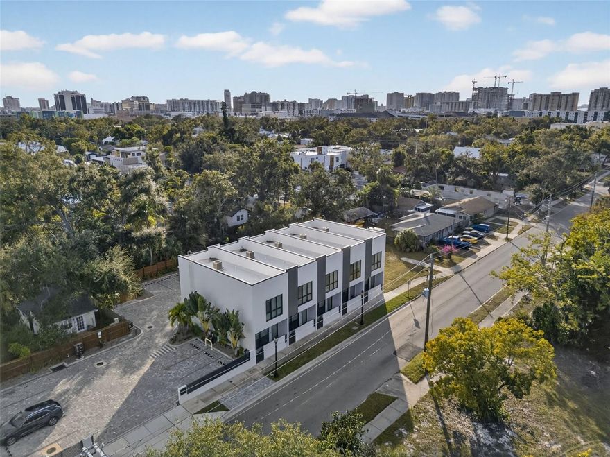 Enjoy new construction just steps from Sarasota's renowned 10-acre Gillespie Park and minutes to the Rosemary District and downtown. This never lived in townhome offers the perfect balance of walkable city living and a peaceful park-side setting, with 2 bedrooms, 2.5 baths, and 2 assigned parking spaces with direct access to the residence. Inside, the open floor plan is designed for both everyday comfort and entertaining, featuring a contemporary kitchen with stone countertops, stainless steel appliances, and quality cabinetry. Thoughtful finishes throughout include hardwood bamboo flooring, designer tile baths, impact windows and doors, and a full-size washer and dryer. Solid concrete block construction with sound-dampening insulation creates an impressively quiet interior, while smart home features and energy-efficient systems enhance convenience and comfort.
Step outside to your own outdoor grill and seating area, then take advantage of Gillespie Park's pickleball, tennis and basketball courts, playground, dog park, and shaded green space right across the street. Located in Flood Zone X with a foundation elevated over 18 feet above sea level, this home offers additional peace of mind. A rare opportunity for low-maintenance downtown Sarasota living in a truly move-in-ready new home.