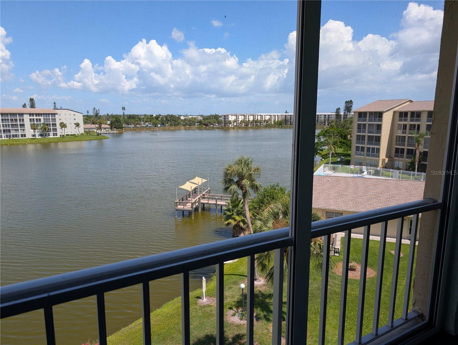ANNUAL RENTAL in 55+ Condo Assoc. You'll appreciated the Penthouse Views of the lake from this top floor (5th), spacious 2BR/2BA condo. Morning sunshine over the water. Partially Furnished! Upgraded throughout...from the gleaming hardwood flooring to the fully-equipped kitchen with beautiful granite countertops including on the breakfast bar, finely detailed wood cabinets, a powerful microwave/convection oven, dishwasher, tile backsplash & more. The guest bedroom has newer carpeting & features a space-saving Murphy Bed with 2 twins beds. Both bathrooms have been updated too. It's an end unit, so there's extra light from the side as well. Finally, Washer & Dryer included on lanai. Another huge feature are the electric hurricane shutters to help you rest easy during storms or even to lower part way if the sun's too bright! Perfect parking spot - #509 next to elevator/stairs! Friendly condo association has heated pool, clubhouse, gas grills/picnic tables, shuffleboard, elevators. Cable & internet included. Not far from places to eat, shop, golf, beaches...you name it. RENTAL TERMS: $1400/month plus utilities (electric, water/sewer). Requirements: 1st + last month rent + $500 damage deposit + $150 cleaning fee + $100 condo application fee. NO SMOKING, NO PETS. Interested? Don't wait....