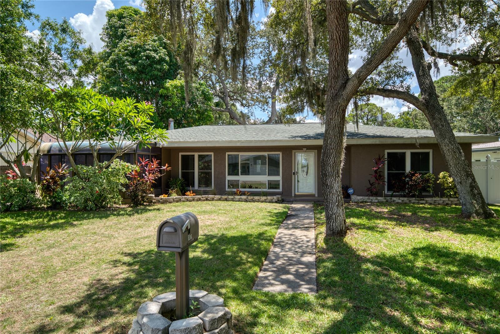 One or more photo(s) has been virtually staged. Welcome to 1807 Sunrise Blvd, a beautifully updated four-bedroom, three-bathroom pool home, located in the desirable Sunrise Vista neighborhood. This versatile home is packed with bonus spaces, including a third bedroom that is also a perfect office space, and a bright, air-conditioned sunroom with French doors opening to partial Tampa Bay views connected to the fourth bedroom with direct outside access. Upon entry, you’re welcomed by an open-concept layout with a spacious living room, breakfast nook, and modern kitchen. Just off the breakfast nook, the fourth bedroom features a built-in electric fireplace, providing warmth and ambiance, as well as the air conditioned sunroom. A full guest bathroom is located to the right of the living room, and the front bedroom includes an en-suite bathroom with a sleek walk-in shower. Moving past the kitchen, a flexible bonus room (Office or the third bedroom) sits to the right, and the formal dining room to the left. The family room, ideal for relaxing and entertaining, overlooks the private backyard and sparkling in-ground pool. The primary suite features two walk-in closets, a chic water closet with barn door entry, a walk-in shower, and a luxurious stand-alone bathtub. Outdoor living is enhanced by a covered patio, raised deck, and a versatile storage shed that could be transformed into an outdoor bar. There’s ample parking with a rear driveway and garage, plus convenient options for boat or RV parking. Currently operating as a profitable short-term rental with active bookings, this property is an ideal investment opportunity or a serene family retreat. Furnishings are available, making it a seamless transition for new owners or investors. Located close to CCC High School, Cove Cay Golf Club, and with easy access to Clearwater Airport and major highways, this home is perfectly situated. Don’t miss the chance to see this one-of-a-kind property – schedule your private tour today!