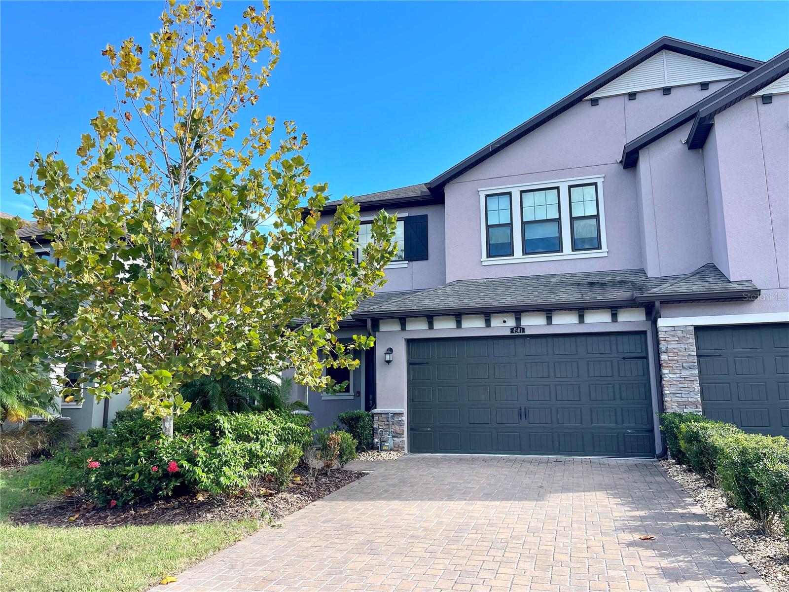 Experience modern living in this beautiful townhome ideally located in the heart of Wesley Chapel, just minutes from I-75. This spacious 3-bedroom, 2.5-bath townhome includes an attached 2-car garage and offers a perfect blend of comfort, style, and functionality. The kitchen is a true highlight, featuring 42 shaker cabinets, stainless steel appliances, granite countertops, a pantry, and a large island with barstool seating that overlooks the open living and dining areas. A versatile office/den on the first floor provides an ideal space for work or study. Step outside to the extended lanai with an automatic screen enclosure, perfect for relaxing or entertaining. Upstairs, the expansive primary suite offers a private retreat complete with a walk-in closet with built-ins, a luxurious en-suite bath with an oversized shower, dual vanities, and access to a private balcony. Enjoy resort-style community amenities including a sparkling pool, clubhouse, fitness center, playground, and tennis courts. Conveniently located near The Shops at Wiregrass, Tampa Premium Outlets, and an array of popular dining destinations. Make this home yours today!