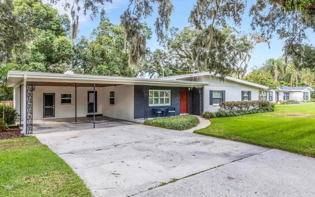 Just 0.6 miles from Lake Hollingsworth, this beautifully updated Mid-Century Modern home offers 3BR/2BA and 1,620 sq ft of style and comfort on one of Lakeland’s most sought after streets, Easton Drive. The family room features an original Heatilator fireplace with craftsman-styled vents to warm the entire space, while original terrazzo floors flow throughout the entire open layout. The fully updated kitchen boasts 42? Wellborn wood cabinets, granite countertops, and a coffee bar, with French doors opening to a screened-in pool and cozy, private fenced backyard. Recent upgrades include a TPO roof (2017) and double-paned insulated windows with plantation shutters. The pool, renovated in 2015, features a Durabrite surface, updated tile, sun seat, and a refreshed brick paver deck. Surrounded by mature oaks in a tranquil setting, this home is near to everything: parks, trails, golf, tennis, shopping, and downtown dining—with no HOA. Move-in ready and priced to sell quickly!