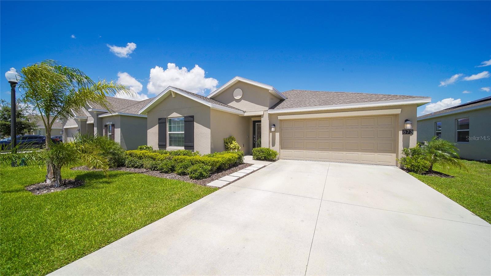 Welcome to 873 Laurel View Way, a stunning 2023-built, 1,936 sq. ft. single-family home in the prestigious Bellevue neighborhood of Estates at Cherry Lake! This 4-bedroom, 2-bathroom masterpiece blends modern elegance with practical upgrades, perfect for families or entertainers seeking the ultimate Florida lifestyle. Step into a bright, open-concept layout illuminated by UPGRADED LIGHTING FIXTURES, including designer chandeliers, recessed LEDs, stylish pendants, and UNDER-COUNTER LIGHTING IN THE KITCHEN that enhances functionality and ambiance for meal prep and entertaining. CEILING FANS THROUGHOUT the living areas and bedrooms provide energy-efficient cooling and stylish comfort tailored to Florida’s climate. The gourmet kitchen is a chef’s dream, featuring a large center island, solid quartz countertops, 36” soft-close cabinets with crown molding, energy-efficient appliances, and a REVERSE OSMOSIS WATER FILTRATION SYSTEM under the sink, delivering pure, contaminant-free drinking water via a dedicated faucet—perfect for cooking and hydration. The kitchen flows seamlessly into a spacious café and family room, ideal for gatherings.The oversized owner’s suite is a serene retreat, boasting a spa-inspired bathroom with dual sinks, a soaking tub, a separate shower, and ACCENT LIGHTING IN THE VANITY, creating a luxurious ambiance. The generous walk-in closet features UPGRADED SHELVING with adjustable shelves, hanging rods, and built-in storage for clothes, shoes, and accessories, enhanced by ACCENT LIGHTING that highlights its organization and elegance. Three additional bedrooms offer versatility for guests, a home office, or hobbies.The outdoor space is exceptional, featuring a beautifully PAVERED BACK PATIO perfect for entertaining, a FULLY FENCED BACKYARD ensuring privacy with no rear neighbors, and an 8X16 FT. WORKSHOP (128 sq. ft.) ideal for hobbies, storage, or a home gym. The garage is a standout, equipped with a SPLIT UNIT HVAC SYSTEM for year-round comfort and a CUSTOM UTILITY LIFT, perfect to lift heavy objects into the attic storage. The dedicated laundry room is elevated with custom cabinets over the washer and dryer, offering ample storage for detergents, linens, and household essentials. The home has smart home automation, including keyless door locks, video doorbells, and seamless Wi-Fi connectivity with no dead spots. Energy-efficient appliances, green building features, upgraded tile, and premium kitchen and bath fixtures ensure comfort and cost savings. Nestled in the tranquil Bellevue at Estates at Cherry Lake, enjoy community amenities like a park, walking trails, picnic areas, and private access to Cherry Lake. Located just 45 minutes from Orlando International Airport, minutes from I-4, Florida’s Turnpike, and Lakeridge Winery, and a short drive to Clermont’s vibrant dining, shopping, and Orlando’s world-class attractions, this home perfectly balances rural serenity with urban convenience.Don’t miss this nearly new, move-in-ready gem.