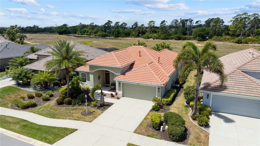 Welcome to the gated community of Bobcat Trail. Here you will find the vibe is tranquil, the neighbors are social, and your biggest daily decision might just be coffee on the front porch or a cocktail by the pool?  This home delivers that easy breezy, Florida lifestyle coupled with sophistication. Step inside and you’re immediately greeted by a soothing, calming feel. The glass door allows the home to fill with sunshine and the color choices are warm and inviting. The versatile floor plan flows naturally into comfortable spaces. The 90 degree, disappearing slider extends your living space outdoors. The family room, living room and dining room could be interchanged to fit what works well for you. The kitchen serves as the hub of the space and and you will never feel isolated from your guests or family while you are making dinner or hiding the take out containers. Your secret is safe with us. The passion may return, because now you are cooking with gas. We know first hand that your guests will gather at the breakfast bar waiting for the next mystery drink to pour from the shaker. For those nights when you are opening the doors to overnight guests, the split bedroom design is clutch. You retire into your spacious sanctuary and they find solitude on their side of the home. Keep the pool fountain running and crack the bedroom slider and the sounds of the fountain will have you snoring in no time. Well that is until you get that elbow from the one next to you. The bathroom is designed for sharing with double sinks, two closets, a walk in shower, and a tub to host your bubble baths. The guest bathroom doubles as a pool bath, so no more wet feet across your living room floor. When you step outside you will be certain Florida was the right move. The elongated lanai is hugged by landscape to give it mother natures kiss. The heated pool and spa with a cascading fountain sets the tone for relaxation and something to subtly brag about to your Northern friends. Morning swims, evening dips, and smells from the grill will make you forget what day it is. Or it may have been the martini, who knows. If you are retired, it doesn't even matter.  So much room around the pool to set up the loungers and receive your Vitamin D infusions. The Storm Smart screening provides both protection from the sun and the weather, if you are one that prefers the shade. You can electronically open, close or stop somewhere in between.  We can't forget about the front porch sitting area.  Perfect for slow mornings and people watching. This street will always have someone walking, biking, or jogging by. For those of us with heavy feet, electric golf carts are allowed. And then there’s the community, Bobcat Trail is known for its social atmosphere, active lifestyle, and amenities including tennis, pickleball, and a community pool. The golf course? Recently sold and expected to comeback so therefore opportunity is knocking. Prices reflect the before and not the after. If you’ve been patiently waiting for the right home, the right feel, and the right timing, we are here to show you around.