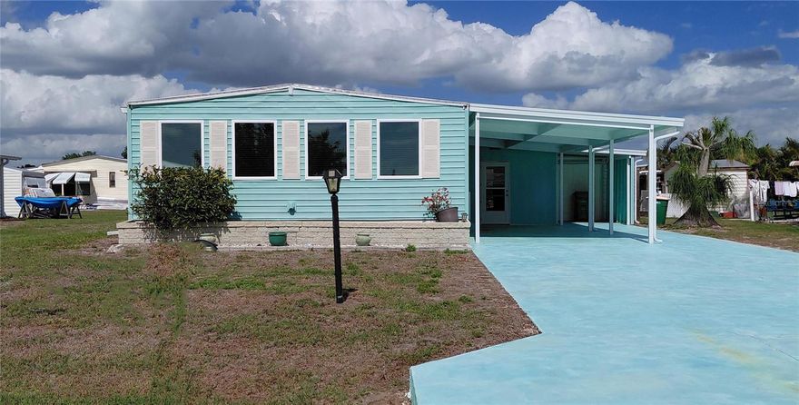 "Updated and Turnkey Furnished Double Wide" 2 bedroom, 2 bath & 2 space carport, + an exterior laundry building nice size with window and 2 doors and room for storage.  In addition an extra wide driveway with additional covered parking. Holiday Mobile Estates is centrally located in the heart of Englewood with everything you need close by; Walmart, Publix, Beaches, Hospital, Restaurants and more. North East Rear Facing and small patio out back, public utilities and optional membership to the Edgewater Club.
Volunteer Association and a 55+ community offers quietness and retirement environment. Move-in Ready!