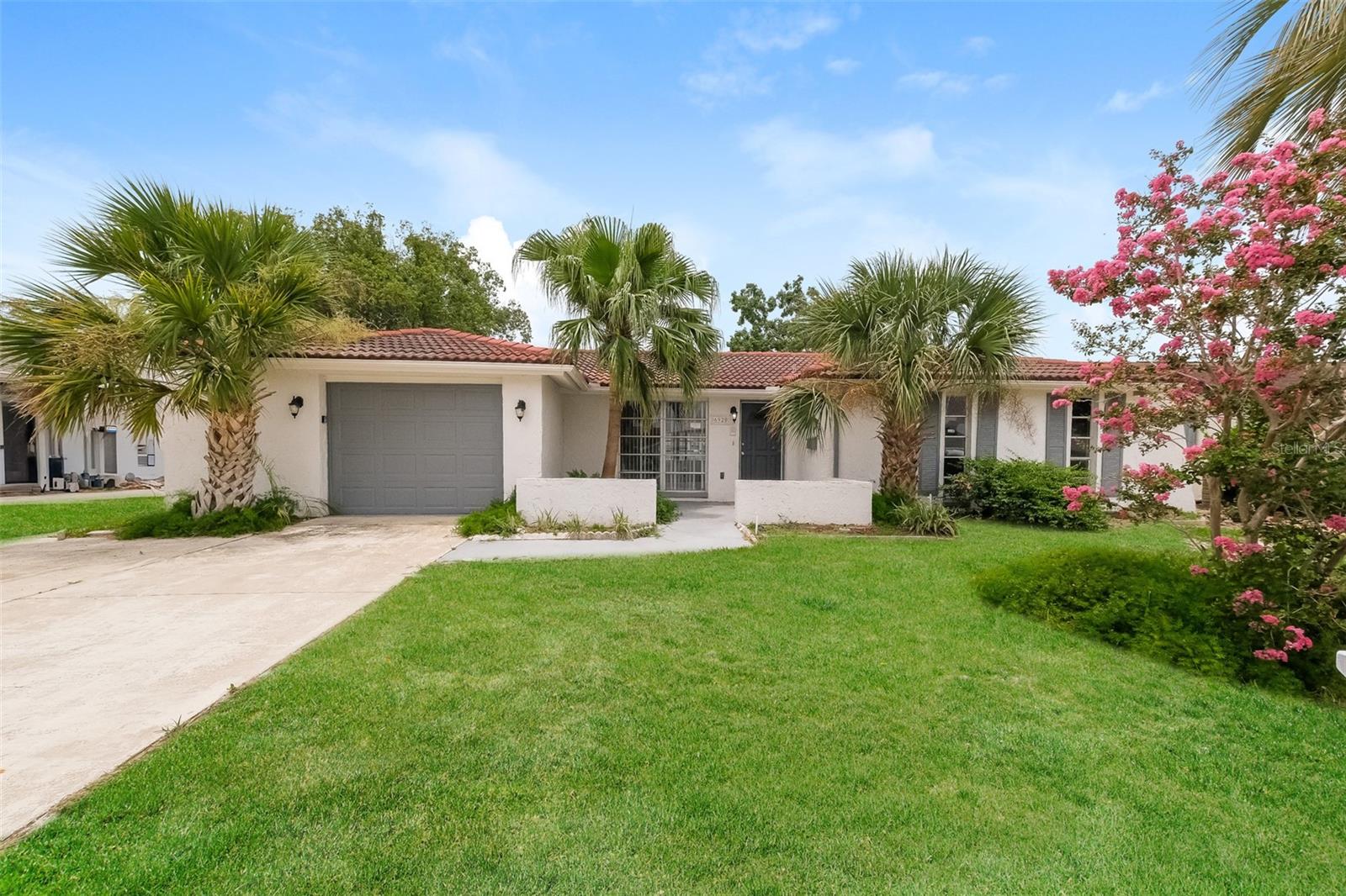 Charm and curb appeal abound for this Port Richey home! Step inside into the well-appointed living room and into the home's dining room, positioned at the center of the home. Through the breakfast nook you'll find the kitchen, which boasts stainless steel appliances, hard surface countertops, and ample storage. Rounding out this ranch style floorplan is the primary suite, two secondary bedrooms, and a sunroom, perfect for year-round enjoyment. Come and see for yourself the possibilities that this home has to offer!