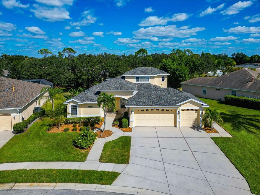 This beautifully maintained five-bedroom, three-bath pool home with a three-car garage is ideally situated on a quiet cul-de-sac in the highly desirable Riverwalk community of Lakewood Ranch. The original owner has thoughtfully maintained the home inside and out, showcasing care, quality, and comfort throughout.

The open and inviting layout offers plenty of flexibility for family and guests. Upstairs you’ll find two large bedrooms and a full bath, perfect for children, extended family, or a home office setup. On the main level, two additional guest rooms share a full bath, while the primary suite provides a peaceful retreat featuring a garden tub, large walk-in shower, dual vanities, and walk-in closet.

The kitchen has been beautifully refreshed with quartz countertops, stainless steel appliances, and a natural gas range—ideal for everyday cooking or entertaining. The living areas open to a screened lanai and sparkling pool, creating a perfect indoor-outdoor flow for Florida living. The large lawn provides ample space for play, gardening, or simply enjoying the quiet cul-de-sac setting.

A true standout feature of this property is the three-car garage, offering an 8-foot-high and 18-foot-wide opening—a rare and valuable upgrade that can easily accommodate a boat, SUV, or recreational equipment. Most Florida garages are smaller, making this a key benefit for storage or hobby needs.

Additional features include fresh interior and exterior paint, reclaimed water for irrigation, and low HOA fees. Riverwalk residents enjoy scenic walking trails, mature landscaping, and the established charm that has made Lakewood Ranch one of the nation’s top-selling communities.

This home is minutes from Lakewood Ranch Main Street, the hospital and medical district, UTC’s shopping and dining, top-rated schools, and the Sarasota-Bradenton International Airport (just 20 minutes away). Easy access to I-75, downtown Sarasota, and the area’s Gulf Coast beaches completes the perfect combination of comfort, convenience, and location.

Beautifully maintained, thoughtfully updated, and move-in ready—this home offers the ideal balance of space, quality, and lifestyle in one of Lakewood Ranch’s most beloved neighborhoods.