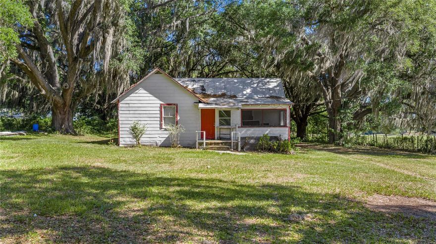 Rolling acreage with gentle elevation changes and established pasture, held within the same family for decades and positioned in a quiet pocket of NW Ocala. Mature oaks frame the homesite and open the door for a true farm setting or future build with a private entrance. Located just minutes from everyday essentials including grocery, restaurants, hardware, and I 75.

The property includes an existing 1948 residence offering 2 bedrooms, 1 bath, and approximately 944 square feet of living space. Features include an enclosed front porch, indoor laundry, central air, well and septic, and a large fenced backyard with shaded areas suited for gardening or outdoor use.

Surrounded by wide open space and set in a peaceful, rural environment with nearby fire stations and a sheriff substation within a short drive. A strong opportunity for those looking to establish a homestead, expand, or build while enjoying the privacy and setting this part of Marion County is known for.