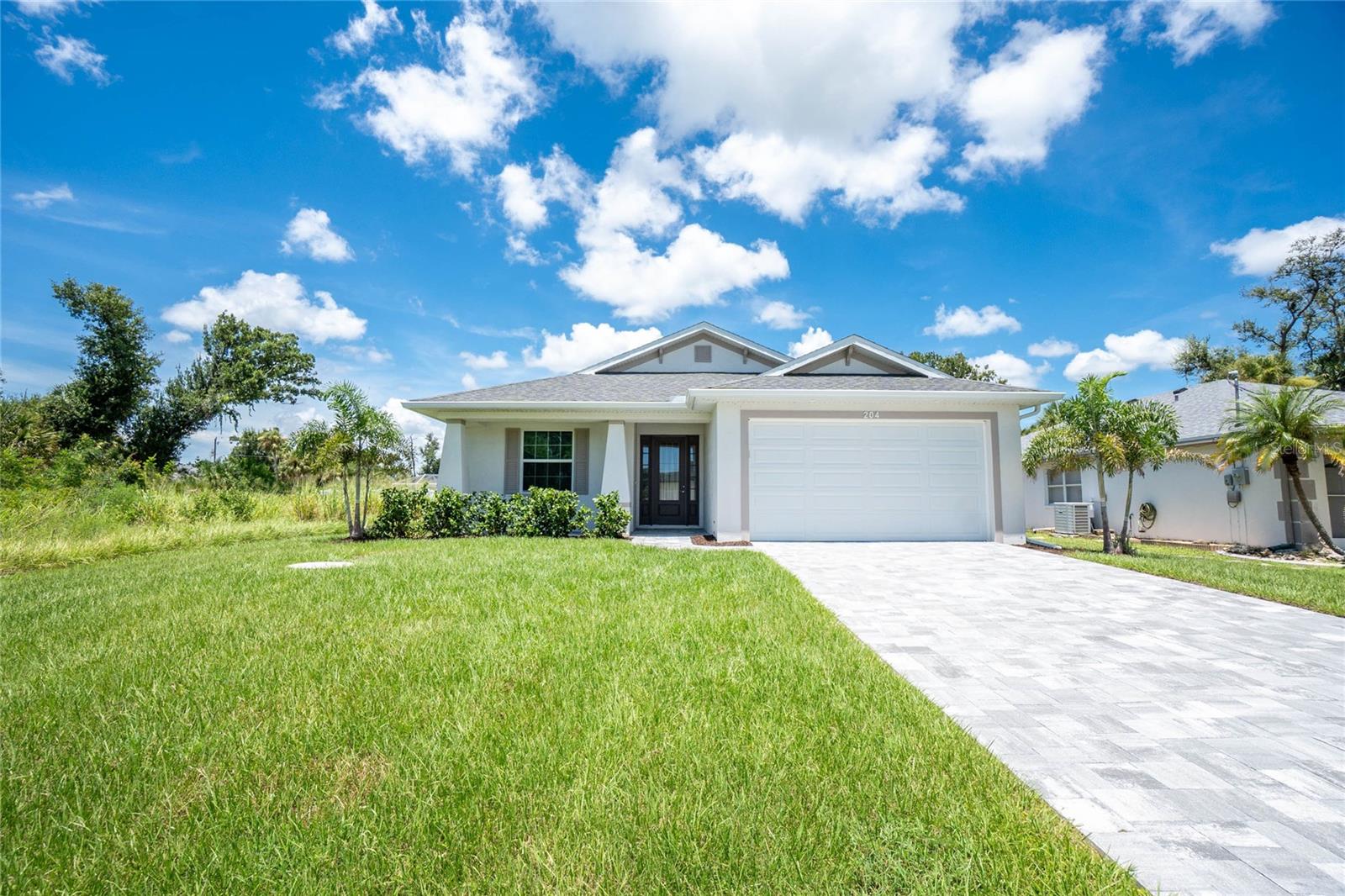 Why build when you can own this extraordinary 2023-built, never-lived-in concrete block pool home in Rotonda Heights! A paver driveway and decorative columns on the inviting front porch set the tone for what lies inside.This three-bedroom, two-bath home showcases designer tile throughout, upgraded plumbing fixtures, ceiling fans, stylish light fixtures, 8-foot doors, spray foam insulation, and neutral wall colors that enhance its light, bright interior. If you love entertaining, the open-concept great room with tray ceiling and molding, kitchen, and dining area provide the perfect setting for easy conversations with friends and family during gatherings. The chef in the family will appreciate the white shaker style cabinets with soft-close doors, level 3 granite countertops, stainless steel appliances, and a large center island with breakfast bar in the kitchen. The ensuite primary bedroom offers a walk-in closet, sliding door access to the pool area, and a luxurious bathroom with a dual sink granite-topped vanity, a walk-in shower, and an additional walk-in closet. The two guest bedrooms each feature reach-in closets, while the guest bathroom offers a coordinating granite-topped vanity and a tub/shower combo for added convenience. An interior laundry room has a granite topped laundry sink and shelving to provide additional storage. The triple pocketing sliding glass doors in the great room seamlessly extend your living space to the expansive paver lanai, complete with ceiling fans and serene wooded views. The pool offers the perfect place to float your cares away. Additional highlights include impact doors and windows throughout the home, a X flood zone classification, underground electric, and a nice sized 2-car garage. Rotonda Heights is a peaceful community in a picturesque setting, offering serene lakes, plenty of outdoor activities, and convenient access to nearby golf courses, parks, and white sand Gulf Coast beaches. This is an ideal place for those seeking a relaxed yet active Florida lifestyle, contact us today to schedule your private showing.