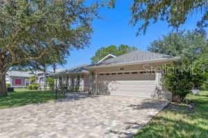 Don't miss this GOLF COURSE beauty with UPGRADES at every turn! Located in The Plantation at Leesburg – 55+ Resort-Style Community! Perfectly positioned on a PRIVATE GOLF COURSE LOT, this upgraded single-story home features a neutral-toned exterior, PAVED DRIVEWAY, front and back COURTYARDS, and beautifully landscaped grounds. Inside, WOOD FLOORING flows through the main living areas, leading to a GOURMET KITCHEN with 42” cabinets, PULL-OUT DRAWERS, GRANITE countertops, tile backsplash, under-cabinet lighting, WINE REFRIGERATOR, STAINLESS steel APPLIANCES, and a HUGE double PANTRY. The open floor plan connects the kitchen to the family room, perfect for entertaining. The spacious primary suite offers dual vanities, soaking tub, walk-in shower, and a HUGE CUSTOM WALK-IN CLOSET. The GUEST SUITE accommodates king-size furniture and includes its own PRIVATE BATH with a large walk-in shower and custom walk-in closet. A separate study/home office or flex space adds versatility, and a convenient HALF BATH is ideal for guests. Enjoy panoramic golf course views from the enclosed lanai with a PAVED COURTYARD—perfect for outdoor dining, lounging, or a fire pit. *** ROOF 2021 ** AC 2017 ** ENCLOSED LANAI 2023 ***Additional features include an OVERSIZE 2-car garage, PLANTATION SHUTTERS throughout, and an INSIDE SEPARATE LAUNDRY room. The Plantation at Leesburg offers two golf courses, three clubhouses each with heated pools, tennis courts, pickleball, fitness centers, walking trails, and endless social activities. Conveniently located near shopping, dining, medical facilities, parks, and the airport. Golf-front living at its best—schedule your private showing today!