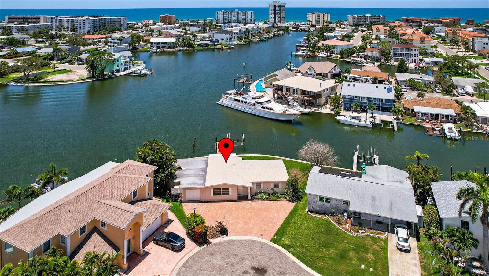 Tremendous opportunity on prime waterfront real estate — priced BELOW FEMA’s lot valuation! This oversized property offers over 122 feet of sailboat-depth water frontage with direct Gulf access via a short boat ride to John’s Pass, making it a highly desirable location for a future luxury new home or remodel potential. From the back patio, enjoy the open water views and beautiful sunsets. The private dock includes a 10,000 lb boat lift and area for an additional slip, enhancing its appeal to boating enthusiasts and high-end coastal buyers. The existing 3-bedroom, 3-bath structure sustained storm damage but has already been remediated, with all compromised materials professionally removed. This is not a substantially damaged home, so renovation is permitted. Whether rehabbing the current structure or building new, the possibilities for strong ROI are significant. Call for a detailed and extremely reasonable rehab estimate or building plans and pricing to construct a new home. Samples of remodel work and model home available to tour. The property is being sold “As-Is” and the seller makes no warranties regarding the home's condition. Buyers to assess the property's suitability for their intended use.