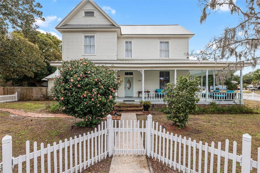 Step back in time and feel at home in this beautifully restored 100+ year-old grand residence in the heart of Lake City—where historic charm meets modern comfort. A brick walkway leads to a gated entry and welcoming covered front porch. Inside, an impressive staircase with classic balusters anchors the home, while original heart pine floors, wainscoting, intricate moldings and soaring ceilings reflect Old Florida elegance.
Offering a flexible floor plan with 3 bedrooms, 3 bathrooms, and multiple gathering spaces, the home spans 2,891 square feet across two floors and can easily accommodates a home office, guest room, or creative space. The living room centers around a fireplace, while the formal dining room features a striking ceiling rosette and its own fireplace. The library has floor-to-ceiling bookshelves, original cabinetry and a vintage wallpaper mural. The kitchen blends seamlessly with the home’s character and includes new stainless steel appliances, a gas range with pot filler, a spacious walk-in pantry and an eat-in area overlooking the front yard. A side entrance offers convenient access from the driveway. The primary suite is vintage in style yet refined, highlighted by a timeless clawfoot tub in the en suite. Two additional bedrooms, each with its own fireplace, share a hall bath and are separated by glass French doors. Situated on a large, fenced lot ideal for gardening, pets, or gatherings, the backyard offers privacy and endless possibilities. Updates include a new metal roof, two-zone HVAC and updated plumbing and electrical (2024). Walkable to downtown shops, restaurants, the courthouse, and Lake Isabella, with easy access to I-75, medical centers, and nearby colleges. A rare opportunity to own a storied home that feels warm, flexible, and ready for its next chapter.