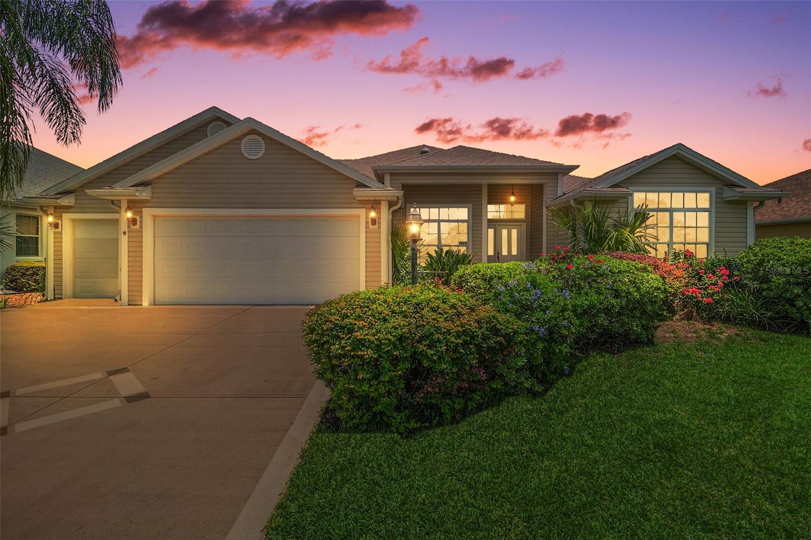 FANTASTIC 3/2 Designer Camellia/Gardenia featuring a FABULOUS ENCLOSED LANAI with HOT TUB and OVERSIZED 696sf GOLF CART GARAGE in the highly sought after village of Poinciana! JUST MINUTES to Lake Sumter Landing and Brownwood Paddock Squares!- NEW ROOF(2025)! - Enhancing the exterior of this GORGEOUS home are DECORATIVELY PAINTED drive and walk ways, MATURE TROPICAL landscaping, and a quaint FRONT PORCH - the perfect spot to SIP your morning coffee or simply RELAX and ENJOY the beautiful Florida weather! Step through a BEAUTIFUL etched glass entry door with retractable screen and large transom window into the BRIGHT, GENEROUS foyer with HIGH ceilings and diagonally TILED flooring. The SPACIOUS kitchen is truly a chef’s delight, boasting RICH WOOD cabinetry, GRANITE countertops, built-in PANTRY, SOLAR TUBE, EAT-IN breakfast bar, and TILED flooring. The adjacent dinette offers ample NATURAL LIGHT with double windows and a large transom window. An OPEN CONCEPT floor plan and HIGH VAULTED CEILINGS of the living and dining rooms create a SPACIOUS and VOLUMINOUS main living area. OPULENT columns add a touch of ELEGANCE to the dining room. From the living room, a DOUBLE set of POCKET sliding glass doors, lead you into the ENCLOSED LANAI featuring an above ground HOT TUB - perfect for unwinding after a long day! This WONDERFUL room boasts TILE floors, PRIVACY landscaping, surrounding FULL LENGTH sliding doors, and a French door to the BRICK PAVER rear patio - ideal for grilling! Back inside, retreat to your luxurious primary suite, boasting TILE flooring, HIGH VAULTED ceiling, TWO WALK-IN closets, and sliding glass doors that open to the ENCLOSED LANAI and HOT TUB. It’s ENSUITE bathroom features WOOD cabinetry, DOUBLE sinks, MAKE-UP vanity, GLASS-ENCLOSED WALK-IN shower with TILE finishes, and a LARGE LINEN closet. A SPLIT FLOOR PLAN, places two additional bedrooms and second bathroom CONVENIENTLY HIDDEN behind a POCKET DOOR, near the front of the house - creating a PRIVATE GUEST WING. Bedroom two (no closet) with BRAND NEW CARPET, DOUBLE windows, and a VAULTED ceiling would make an ideal home office, den, or an additional sleeping area for guests. The second bathroom features TILE floors, WOOD vanity with GRANITE top, TILED tub and shower combination, and a hallway LINEN closet. The third bedroom also offers BRAND NEW CARPET, a large window, and built-in closet. The CENTRALLY LOCATED INTERIOR LAUNDRY ROOM offers WHITE cabinets for additional STORAGE needs, a utility sink, and TILE floors. Completing the package is the AMAZING OVERSIZED 29’x24’ GOLF CART GARAGE boasting painted floors, attic access with stairs, and PLENTY of room for parking and STORAGE! IDEALLY LOCATED- JUST MINUTES from the vibrant Lake Sumter Landing and Brownwood town centers - where you'll have EASY ACCESS to world-class entertainment, shopping, dining! The Village of Poinciana also boasts its own private resident pool, while two additional Village Recreation Centers—Allamanda and Hibiscus—offer an array of recreational opportunities! For golf enthusiasts, Cane Garden Country Club is just a short drive away, featuring a well-equipped pro shop, and 27 holes of challenging championship golf on the Jacaranda, Hibiscus, and Allamanda courses. Nearby 466 and 466A also offer an ABUNDANCE of shopping, restaurants, banks, medical and more! PLEASE WATCH OUR WALKTHROUGH VIDEO OF THIS BEAUTIFUL HOME and CALL TODAY to schedule your Private Showing or Virtual Tour!