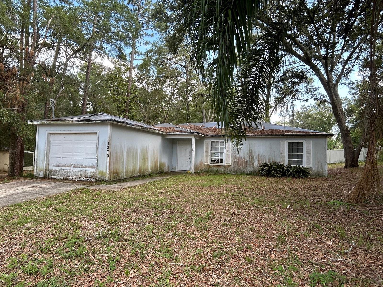 Opportunity awaits! This diamond in the rough sits on an oversized lot shaded by mature trees. 3-bedroom, 2-bathroom home with a 1-car garage offers a unique opportunity for those looking to invest, renovate, or create their dream retreat. Located on a paved street in Orange City, this property boasts a split floor plan and nearly 1,200 square feet of living space—ideal for customizing to fit your needs.
While the home does require significant repairs, it provides a solid canvas with endless potential in a sought-after natural setting. Whether you're envisioning a cozy home or a smart investment project, the charm of the lot and layout sets the stage for transformation.
Situated just minutes from Blue Springs State Park and the St. Johns River, this location is perfect for nature lovers, kayakers, and anyone seeking the tranquility of Florida's scenic waterways—while still enjoying convenient access to local shops, dining, and I-4 for commuting.
If you're ready to bring your vision to life, this could be the hidden gem you’ve been waiting for.