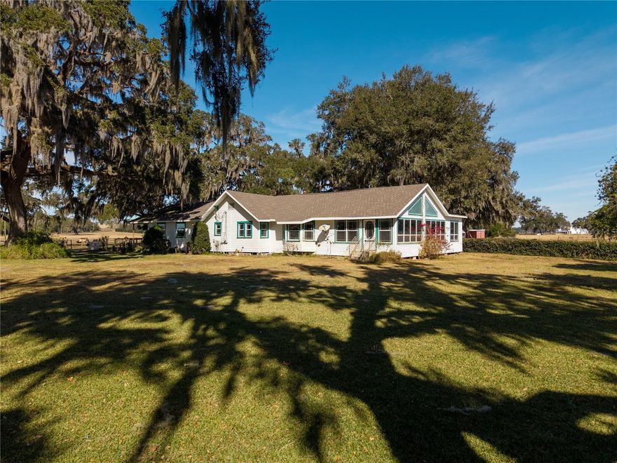 One or more photo(s) has been virtually staged. Welcome to a rare opportunity to own over 11 acres of waterfront usable agricultural land perfectly positioned between Dade City and Zephyrhills. This 5-bedroom, 2.5-bath home blends classic Florida charm with space, privacy, and versatility—ideal for those seeking room to spread out while staying close to everything.

A welcoming front porch shaded by mature oak trees sets the tone as you arrive. Inside, the home features warm wood ceilings, abundant natural light, and a functional layout designed for both everyday living and entertaining. The kitchen offers ample cabinetry, updated appliances, and a bright, open feel, flowing seamlessly into the main living areas.

One of the standout features is the sun-filled enclosed Florida room currently being used as the spa room! Complete with wood-paneled ceilings, expansive windows, and peaceful views of the surrounding property—perfect for relaxing or hosting year-round. The home also includes a large laundry room, providing additional storage and workspace.

Situated just 10 minutes to Dade City, 10 minutes to Zephyrhills, and 20 minutes to Wesley Chapel, this property truly sits in the middle of it all. The expansive acreage includes a barn, shed, and two wells, supporting a variety of agricultural and rural lifestyle uses. The backyard opens up to Sand Pond, offering a serene natural backdrop and added privacy.


With no HOA, over 11 acres to make your own, and multiple existing structures in place, this property is ideal for animals, farming, equipment storage, or a multi-generational compound. Offering a rare combination of acreage, functionality, and location, this is country living with convenience—an opportunity that doesn’t come around often.