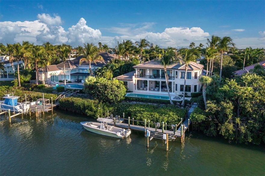 Longboat Key Waterfront Estate Lifestyle
Unrivaled in privacy, craftsmanship, and waterfront lifestyle, this gated Lighthouse Point residence lives like a grand coastal estate, with 4 Bedrooms, 4-1/2 Baths, and nearly 5,000 square feet of refined interiors opening to sweeping terraces on two levels and serene views over a secluded, bridgeless-access lagoon leading directly to the Gulf of Mexico. Extensively renovated in 2021, the two-story Mediterranean-inspired home blends timeless architecture with a sophisticated contemporary aesthetic, framed by manicured tropical grounds on over one-third of an acre in one of Longboat Key’s most exclusive enclaves.
Dramatic Arrival & Entertaining Spaces
A soaring central foyer with coffered tongue-and-groove ceiling, arched French casement doors, and an elegant wraparound catwalk establishes a dramatic sense of arrival while capturing water, sky, and lush landscaping in every direction. The main living area is designed for effortless entertaining, with a sleek wood-and-stone feature wall, modern fireplace, and sculptural Tom Dixon lighting flowing through expansive glass sliders to the waterfront terrace and saltwater pool and spa.
Gourmet Kitchen & Waterfront Lounge
The fully reimagined Cucina Ricci kitchen serves as a chef’s workspace and social hub, with minimalist custom cabinetry, a generous island with seating, and an ultra-premium Miele VitroLine suite including double ovens, induction cooktop, and integrated coffee station. Just beyond, a waterfront lounge or media den opens directly to the covered loggia, creating a seamless indoor-outdoor living experience enhanced by an integrated Yamaha sound system for both interior and exterior zones.
Owner’s Retreat & Guest Level
Perfectly positioned for privacy, the main-level owner’s retreat is a secluded sanctuary with its own hallway entrance, multiple terrace access points, tray ceiling, recessed lighting, and windows on three sides framing tranquil water views. The suite is completed by dual renovated walk-in closets and a spa-inspired bath with oversized vanities, private water closet, and expansive walk-in shower with rain head, while upstairs three en suite guest suites and a mezzanine den provide luxurious accommodations and flexible space.
Resort-Caliber Grounds & Boating
Outside, meticulously lit landscaping, a travertine-framed saltwater pool and spa, and a private dock with 14,000 lb lift, new motors, and enhanced WiFi create a turnkey boating haven with immediate access to Sarasota Bay and the Gulf. Practical amenities include whole-house Kohler generator, hurricane protection, impact glass, large utility room with dual Sub-Zero wine refrigerators, and an oversized three-car garage with EV charger wiring.
Premier Longboat Key Location
Set behind the gates of Lighthouse Point, residents enjoy private tennis, a serene low-density streetscape, and a short walk to the beach. The address is just minutes from the Longboat Key Club’s golf and tennis, the boutiques and restaurants of St. Armands Circle, and the cultural attractions of downtown Sarasota.
Call to Experience This Estate
Schedule your private showing of this Lighthouse Point waterfront estate today to experience the scale, privacy, and curated luxury that define one of Longboat Key’s most coveted addresses. For additional details and a private tour, contact the listing agent to arrange an exclusive, by-appointment-only viewing.