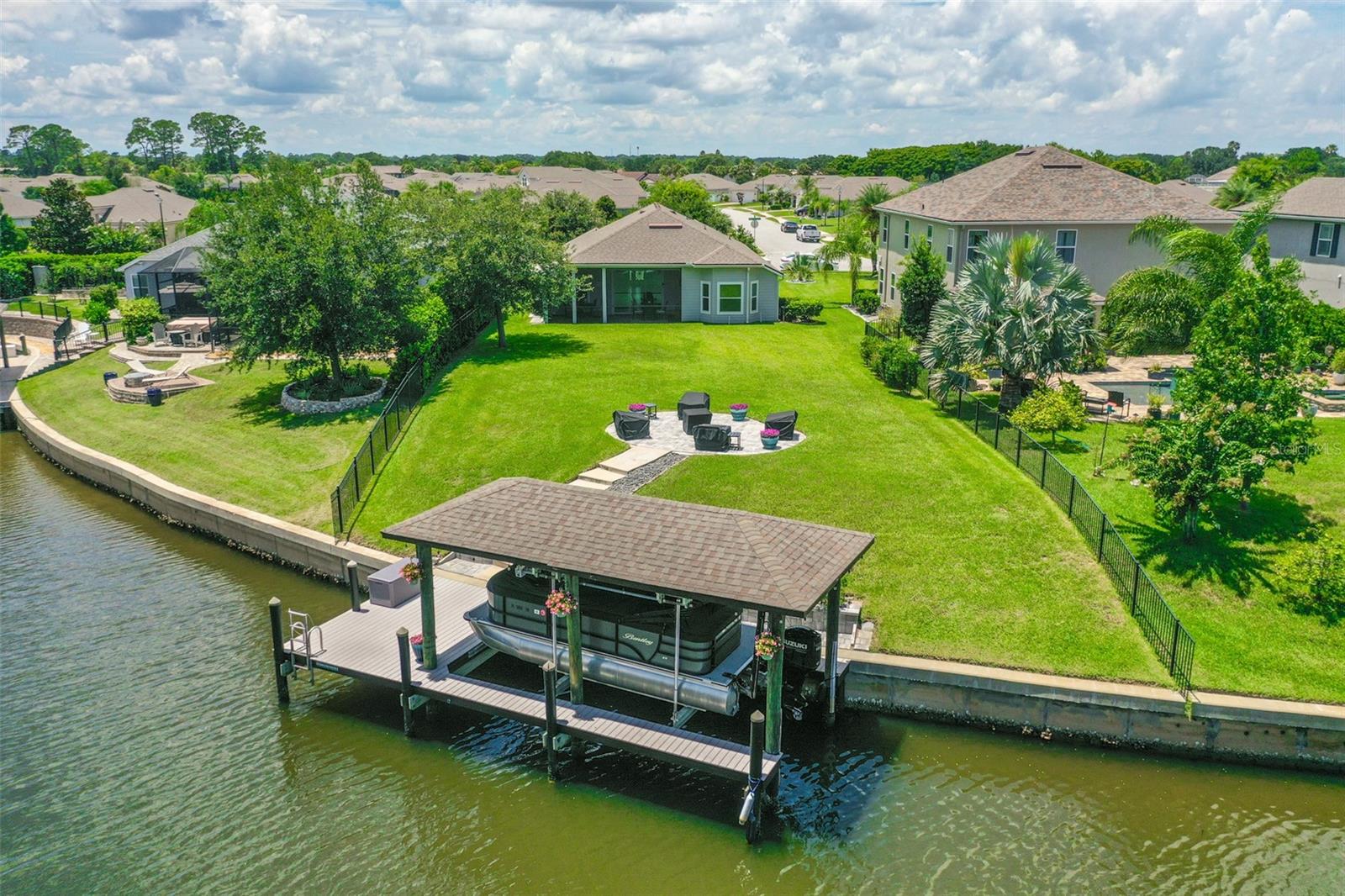 Your Waterfront Paradise Awaits in Country Club Harbour!
Private Gated Community + Underground Utilities
Screened-In-Lanai perfect for relaxing after a day on the water and
FEELING THAT much needed COOL WATER BREEZE. Whether you’re sipping morning coffee or unwinding WITH THAT 5' O'CLOCK SOMEWHERE COCKTAIL GAZING AT THE BEAUTIFUL SUNSET, your LANAI is a year-round sanctuary.
Boathouse with Electric & Water + 10,000 lb Boat Lift
Launch your fishing, power, or leisure boat with ease. Equipped for convenience and built for fun.
Composite Dock & Quick Access to Intracoastal Waterway.
A maintenance-friendly dock leads you just 0.3 miles via saltwater canal to the Intracoastal Waterway—ideal for seamless boating adventures.
Huge lot with plenty of room for a pool, 60ft × 197ft lot nestled at the end of a peaceful cul-de-sac. Plenty of room for outdoor fun, gardening, or kayaks and paddle boards by the water’s edge.
3 Bedrooms 3 Full Bathrooms 2,057 sqft
Comfortable and thoughtfully designed to keep indoor and outdoor lifestyle spaces in harmony.
Ceramic Tile & Open Flow Design
Florida casual meets elegant durability
HOA is just $321 a Quarter
That’s three months of care and community amenities for just over $100 a month for security, upkeep, and neighborhood appeal.
Why is this home Is a Boater’s Dream?
Instant Access to Open Water: Launch the boat, cast a line, or head out for a sunset cruise with minimal effort.
Fishing & Kayaking right at Your Door: Spend less time prepping and more time exploring the mangroves, nearby sandbars, or fishing spots.
Endless Sunshine & Relaxed Vibes!!!!!!!!!!!! You deserve it!!!
Live the Florida Lifestyle every day of your life—where every day is a getaway, the water is your playground, and the sun is your sideline companion. By the way, if you're a golfer... it's only a minute down the street!