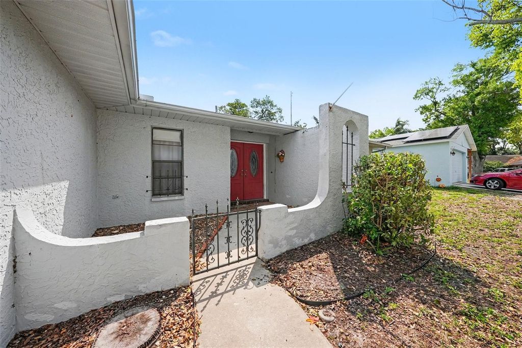 Photo of 8731 Woodcrest Drive, Port Richey, FL 34668 (MLS # TB8490789)