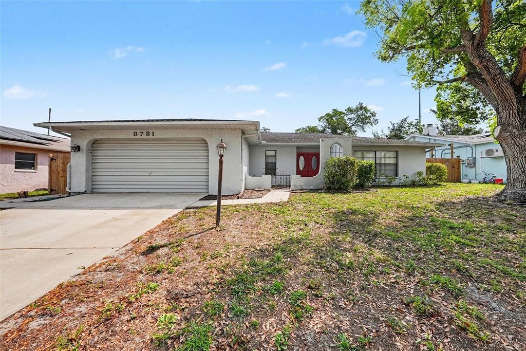 Photo of 8731 Woodcrest Drive, Port Richey, FL 34668 (MLS # TB8490789)