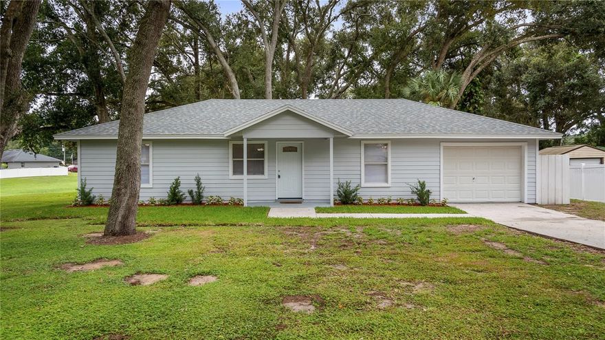 Situated at the end of a peaceful cul-de-sac, this updated 3-bedroom, 2-bathroom home offers comfort, convenience, and the freedom of no HOA! Recently upgraded with a brand-new roof and re-plumbed in 2025. Step inside to find new tile flooring throughout and a desirable split floor plan. Interior is freshly painted too. The home features two nicely sized bedrooms with a full bathroom including a tub/shower combo, while the spacious primary suite is privately located on the opposite side with its own en suite bathroom with tub/shower. The galley-style kitchen overlooks the backyard, providing a peaceful view while you cook. An inside laundry room adds everyday convenience. There’s also a one-car garage for storage and a driveway long enough to accommodate additional parking. Relax and entertain outdoors on the screened-in wood deck patio. Perfectly located near the Minneola Trail, dog park, skatepark, and playground, and just minutes from the Turnpike, local hospital, Highway 27, and Highway 50. This move-in ready home blends comfort, convenience, and an unbeatable location — all without HOA restrictions!