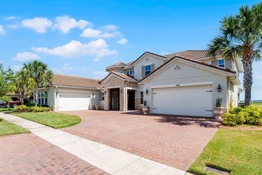 LAKEFRONT LUXURY LIVING in Bellalago! Welcome to this expansive Mediterranean-inspired estate set directly on Lake Tohopekaliga. Built in 2019, this stunning 5,412 sq ft home combines timeless architecture with modern function—offering two 2-car garages, including one oversized with a built-in workshop—perfect for car enthusiasts or hobbyists.Step inside through the gated and screened entry to find soaring 20-foot ceilings and wide-plank flooring that carries throughout the main level. The open-concept design blends formal and casual living beautifully, from the elegant dining area with a dedicated coffee or wine bar to the oversized great room—ideal for hosting large gatherings.The gourmet kitchen is a chef’s dream, featuring 42” cabinets, a glass tile backsplash, granite counters, stainless steel appliances, a walk-in pantry, a butler’s pantry, and a massive island with seating for the whole family. A cozy breakfast nook completes the space, opening seamlessly to a sprawling, screened-in lanai with breathtaking lake views. Enjoy relaxing evenings in the spa under the stars, or add your dream summer kitchen—gas and water lines are already pre-plumbed.With direct access to Lake Toho, boating enthusiasts will love the permitted egress—just add your own dock and hit the water anytime, day or night.The main-floor primary suite offers privacy, its own climate control, a separate entrance to the patio, a spacious custom closet with built-in seating, and a luxurious en-suite bathroom with dual vanities, a soaking tub, water closet, and oversized walk-in shower. A versatile flex room on the first floor is perfect for a home office, studio, or guest space.Also on the main level: a convenient cabana bath, powder room, and full laundry room. Upstairs, you'll find a second full laundry room, a large loft that works perfectly as a media room or lounge, and access to a covered, screened balcony with more panoramic lake views. The junior primary suite features its own full bath, while the remaining bedrooms are generously sized—each with large walk-in closets and shared or en-suite bathrooms. Bedroom 5 also has direct balcony access.Storage won’t be an issue, with multiple storage closets throughout the home—two downstairs and four upstairs.Enjoy the best of resort-style living in Bellalago, a gated waterfront community with a private boat ramp and lift, multiple pools, fitness centers, basketball and tennis courts, a lakeside boardwalk, on-site dining, playgrounds, a dog park, and so much more. Call today to schedule your private tour and experience lakefront elegance firsthand!