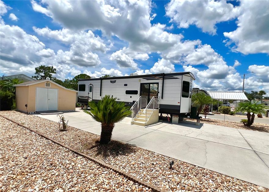 You truly get the perfect package deal when you buy this RV lot that is nestled in a fabulous, well maintained  community with a super low HOA fee of just $210 per YEAR.  It comes with a 43 foot RV that is only 3 years old, (it's a 2022 Wildwood Lodge by Forest River), PLUS you even get the golf cart w/ an on-board charger that is wifi controlled!  The lot is nicely xeriscaped making it practically maintenance free & comes complete w/ all the RV hookups as well as a nice storage shed that has electricity & washer/dryer hook-ups & is the perfect place for housing the golf cart!  The RV is very well maintained & has all kinds of cool features!  It's a 1BR/1BA w/ 2 pull-out couches in the spacious living room, along w/ a quaint faux fireplace w/ a surround sound bar for music & mood lights on both ceiling & floor!    The kitchen is fully equipped w/ all the appliances & has a pantry closet, & a quaint dining area.  The bathroom has a glass enclosed step-in shower & the BR has lots of storage cabinets & drawers including under bed storage.  The windows are tinted w/ life time warranty & there are nice window shades throughout.  There are 3 air conditioning units that are zoned & wifi controlled.  All the furnishings are included & it's pretty much turnkey ready so bring your toothbrush & move right in!  Sun Air North community is affordable living at its finest & there's even community laundry facilities.  It's centrally located between Orlando & Tampa, yet tucked in a rural like setting near some great fishing lakes, nice golf courses 
& not far from some nice restaurants & more!  A great deal you won't want to miss out on & best yet, everything is already all set up for you and ready to enjoy!  Also, note that the seller would consider removing the RV from the lot if the buyer didn't want or need it and just sell the lot, (with attached shed) for a price of $47,900.  All measurements are approximate